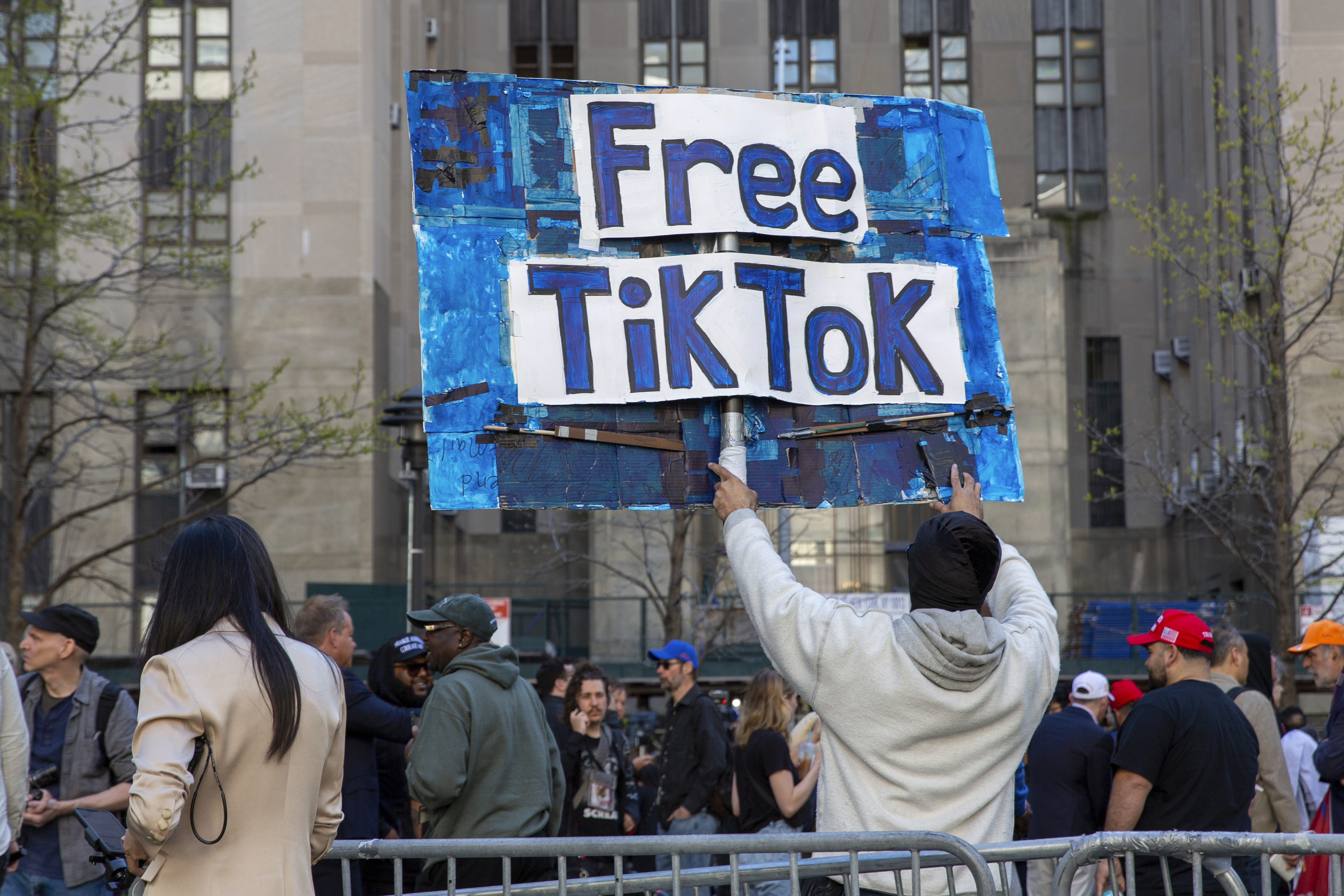 FILE - A man carries a Free TikTok sign in front of the courthouse where the hush-money trial of Donald Trump was underway on April 15, 2024, in New York. (AP Photo/Ted Shaffrey, File)