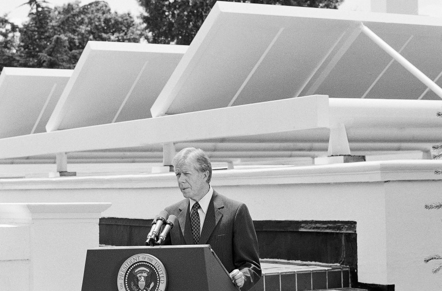 FILE - President Jimmy Carter speaks against a backdrop of solar panels at the White House, June 21, 1979, in Washington. (AP Photo/Harvey Georges, File)