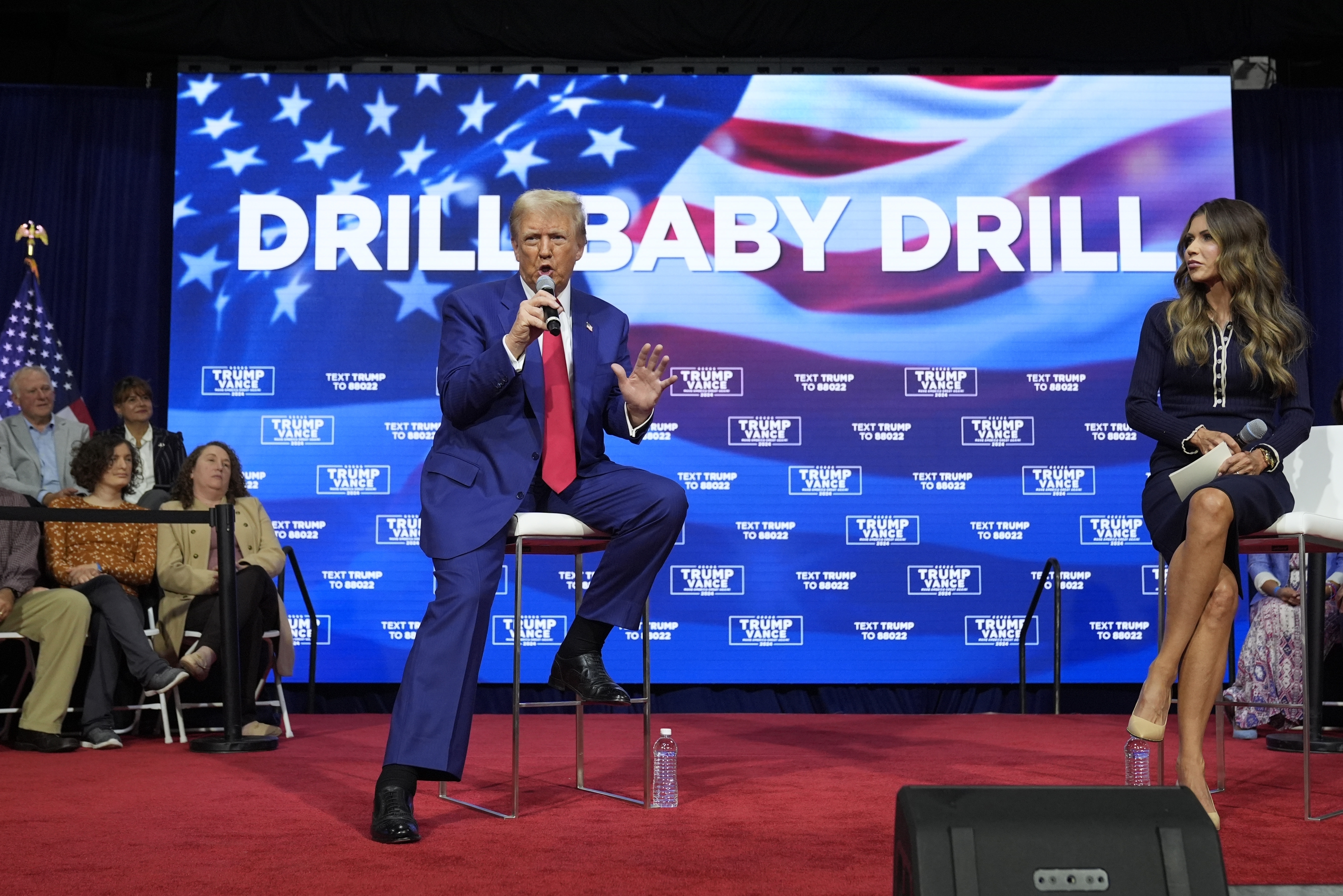 FILE - Republican presidential nominee former President Donald Trump speaks at a campaign town hall at the Greater Philadelphia Expo Center & Fairgrounds, Oct. 14, 2024, in Oaks, Pa., as moderator South Dakota Gov. Kristi Noem listens. (AP Photo/Alex Brandon, File)