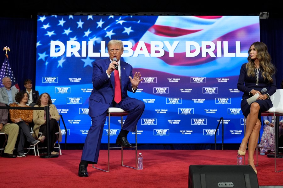 FILE - Republican presidential nominee former President Donald Trump speaks at a campaign town hall at the Greater Philadelphia Expo Center & Fairgrounds, Oct. 14, 2024, in Oaks, Pa., as moderator South Dakota Gov. Kristi Noem listens. (AP Photo/Alex Brandon, File)