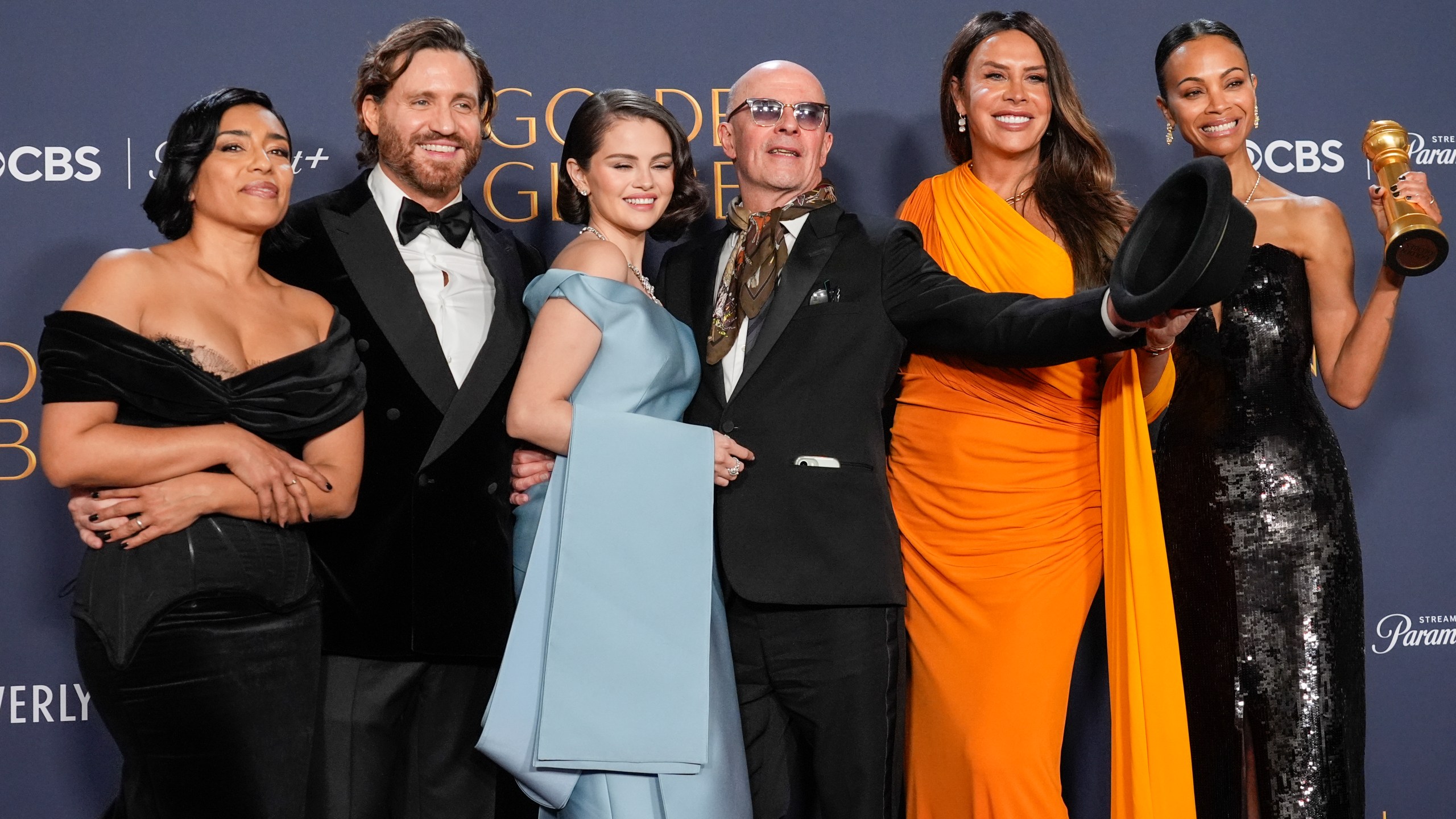 Adriana Paz, from left, Edgar Ramirez, Selena Gomez, Jacques Audiard, Karla Sofia Gascon, and Zoe Saldana pose in the press room with the award for best motion picture - musical or comedy for "Emilia Perez" during the 82nd Golden Globes on Sunday, Jan. 5, 2025, at the Beverly Hilton in Beverly Hills, Calif. (AP Photo/Chris Pizzello)