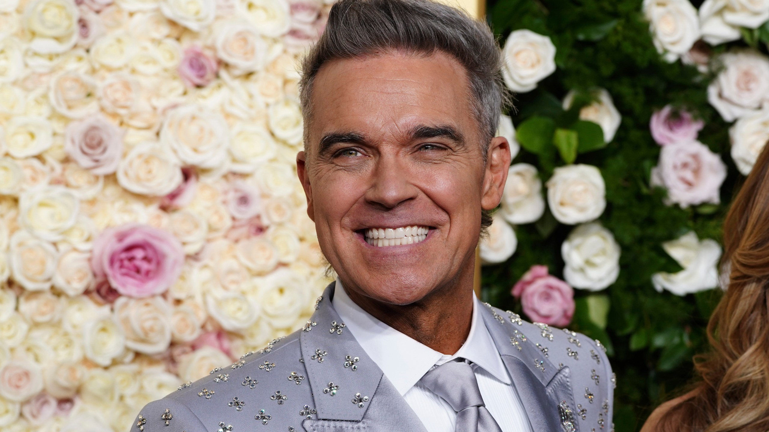 Robbie Williams arrives at the 82nd Golden Globes on Sunday, Jan. 5, 2025, at the Beverly Hilton in Beverly Hills, Calif. (Photo by Jordan Strauss/Invision/AP)