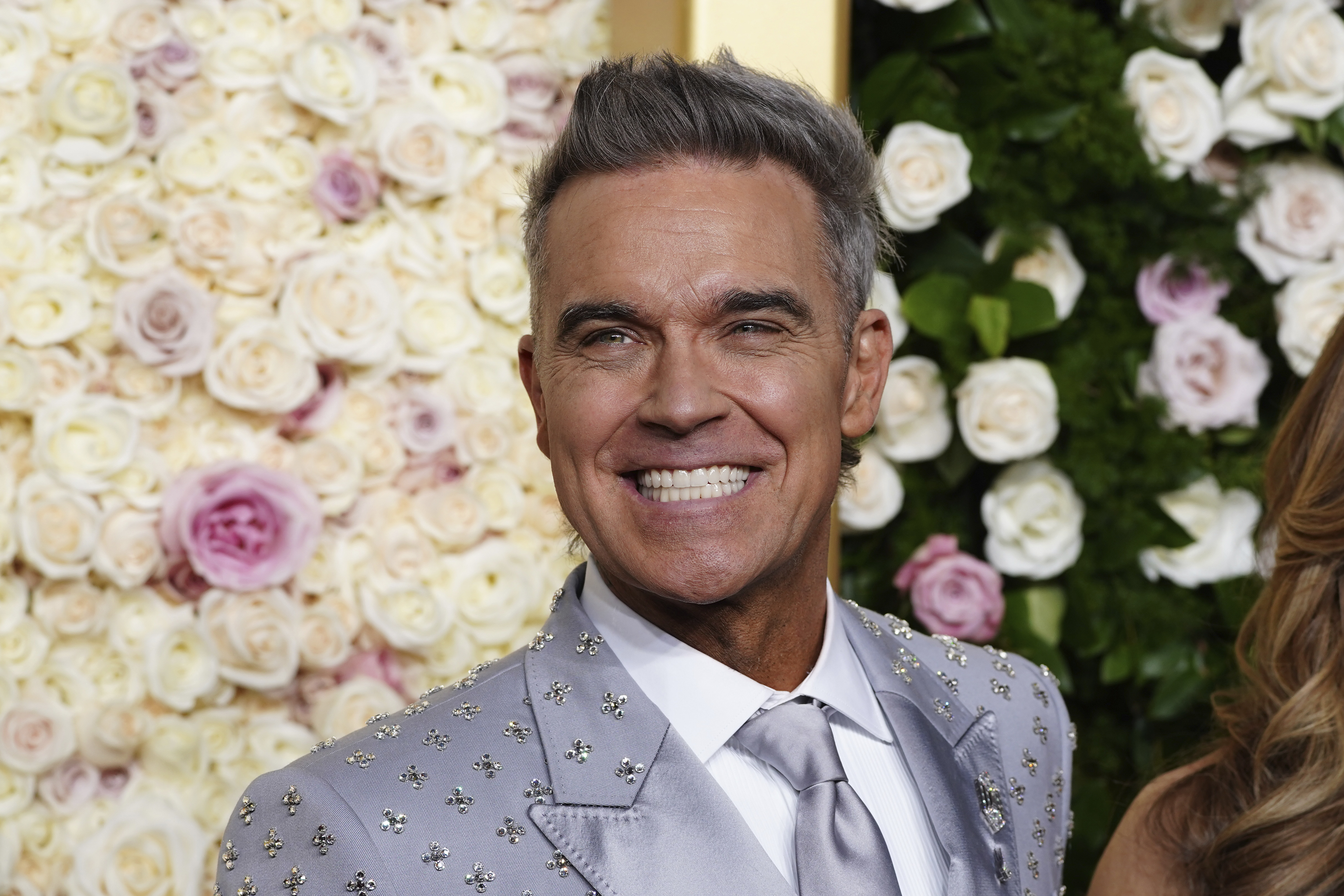 Robbie Williams arrives at the 82nd Golden Globes on Sunday, Jan. 5, 2025, at the Beverly Hilton in Beverly Hills, Calif. (Photo by Jordan Strauss/Invision/AP)