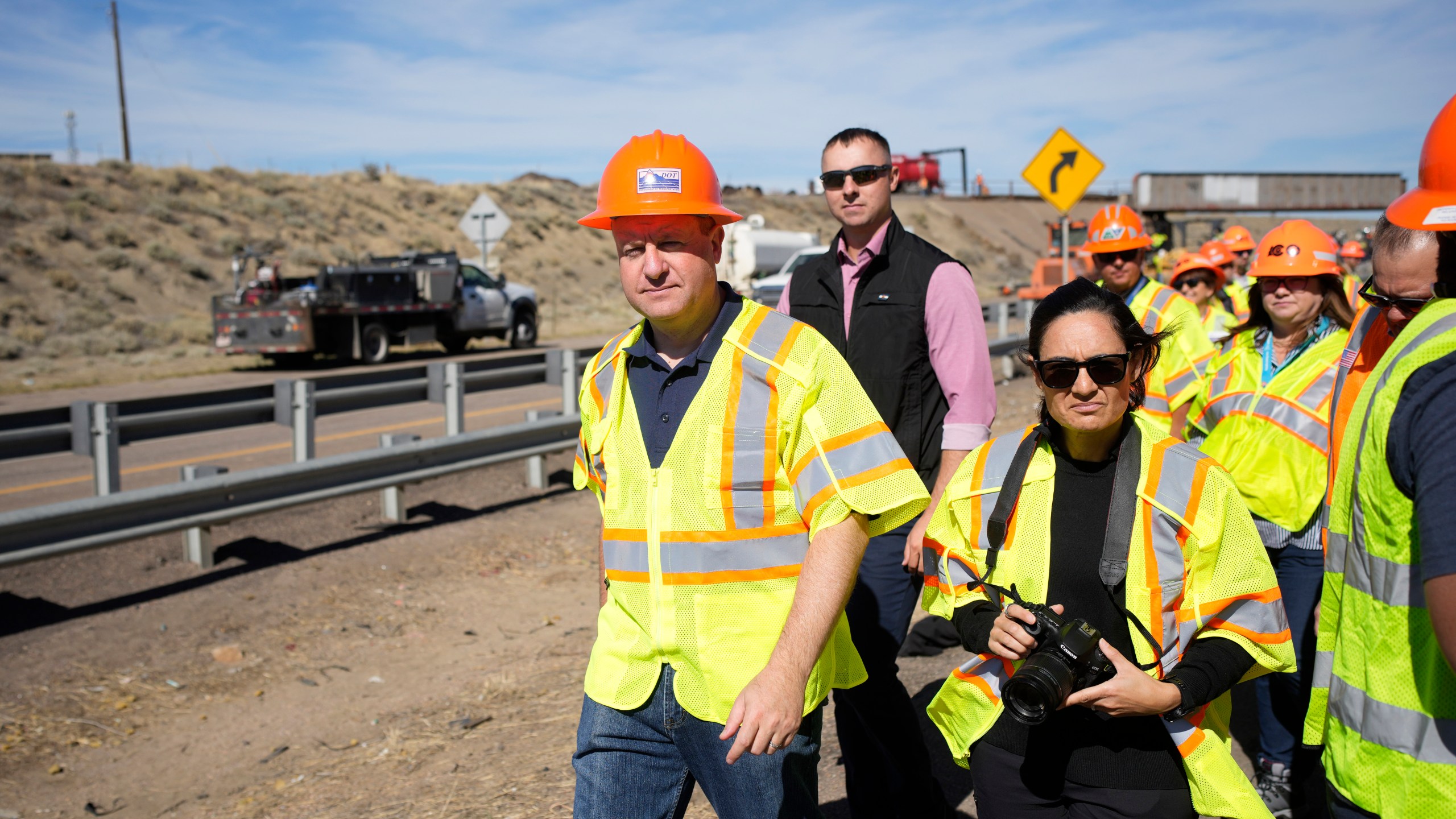 FILE - Colorado Gov. Jared Polis tours as workers toil to resurface Interstate 25 northbound Oct. 18, 2023, north of Pueblo, Colo. (AP Photo/David Zalubowski, File)