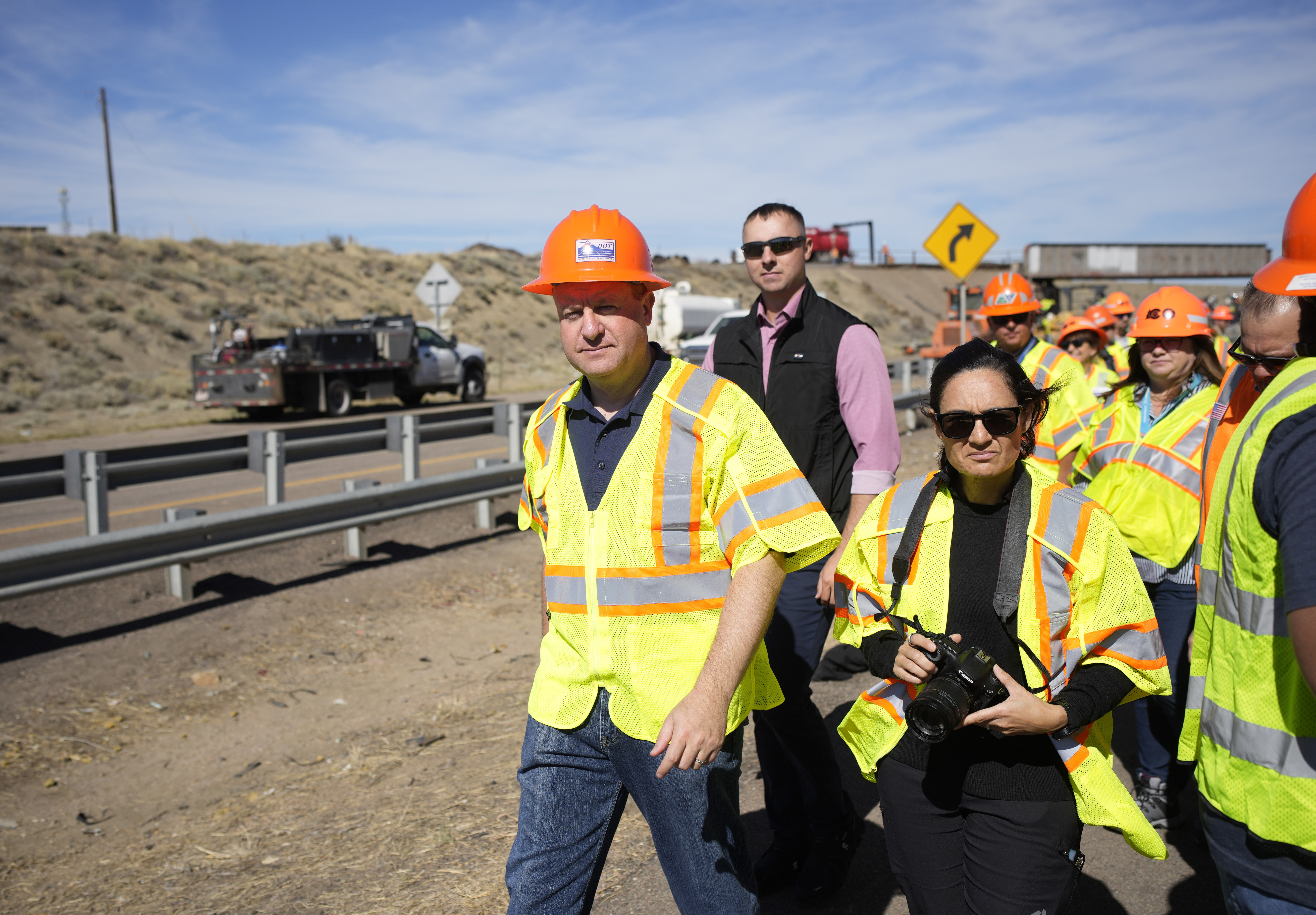 FILE - Colorado Gov. Jared Polis tours as workers toil to resurface Interstate 25 northbound Oct. 18, 2023, north of Pueblo, Colo. (AP Photo/David Zalubowski, File)