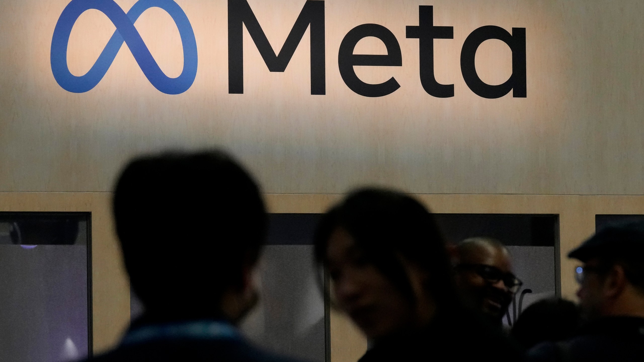 FILE - Attendees visit the Meta booth at the Game Developers Conference in San Francisco on March 22, 2023. (AP Photo/Jeff Chiu, File)