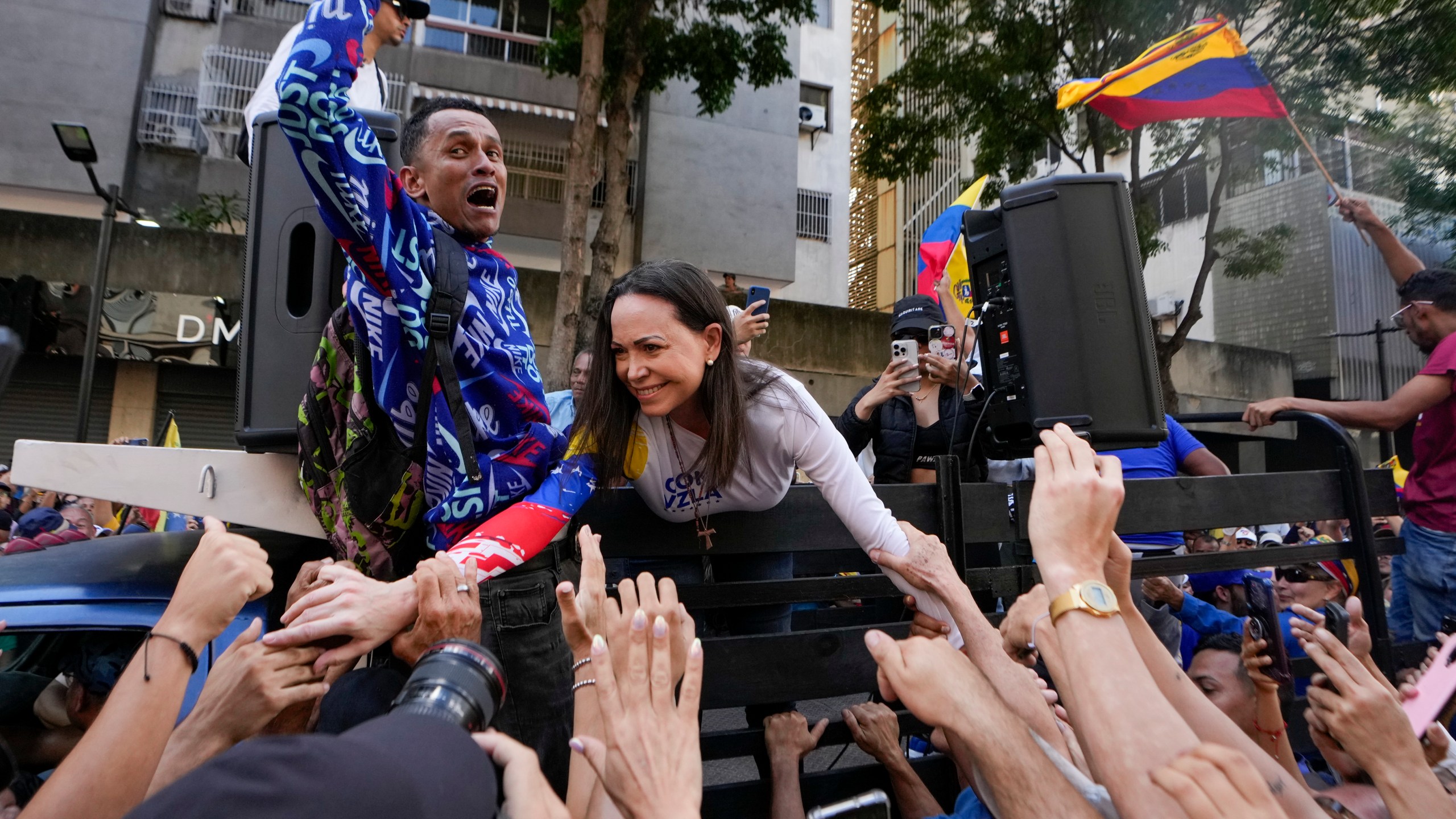 Opposition leader Maria Corina Machado greets supporters during a protest against Venezuelan President Nicolas Maduro the day before his inauguration for a third term in Caracas, Venezuela, Thursday, Jan. 9, 2025. (AP Photo/Matias Delacroix)