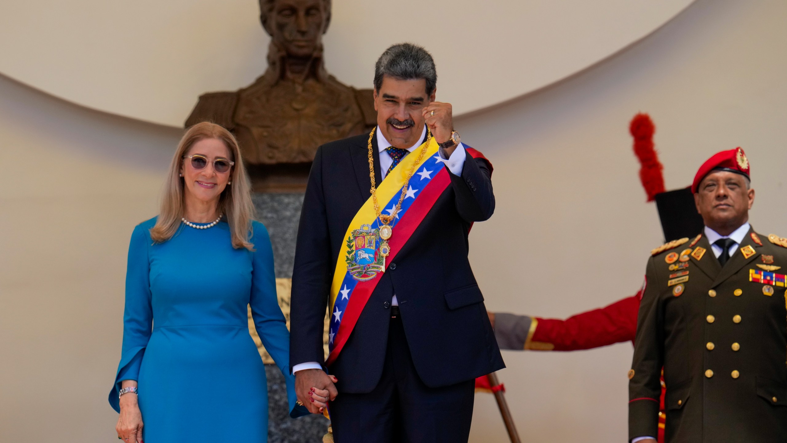 Venezuelan President Nicolas Maduro and his wife Cilia Flores stand at the National Assembly after his swearing-in ceremony for a third term in Caracas, Venezuela, Friday, Jan. 10, 2025. (AP Photo/Ariana Cubillos)