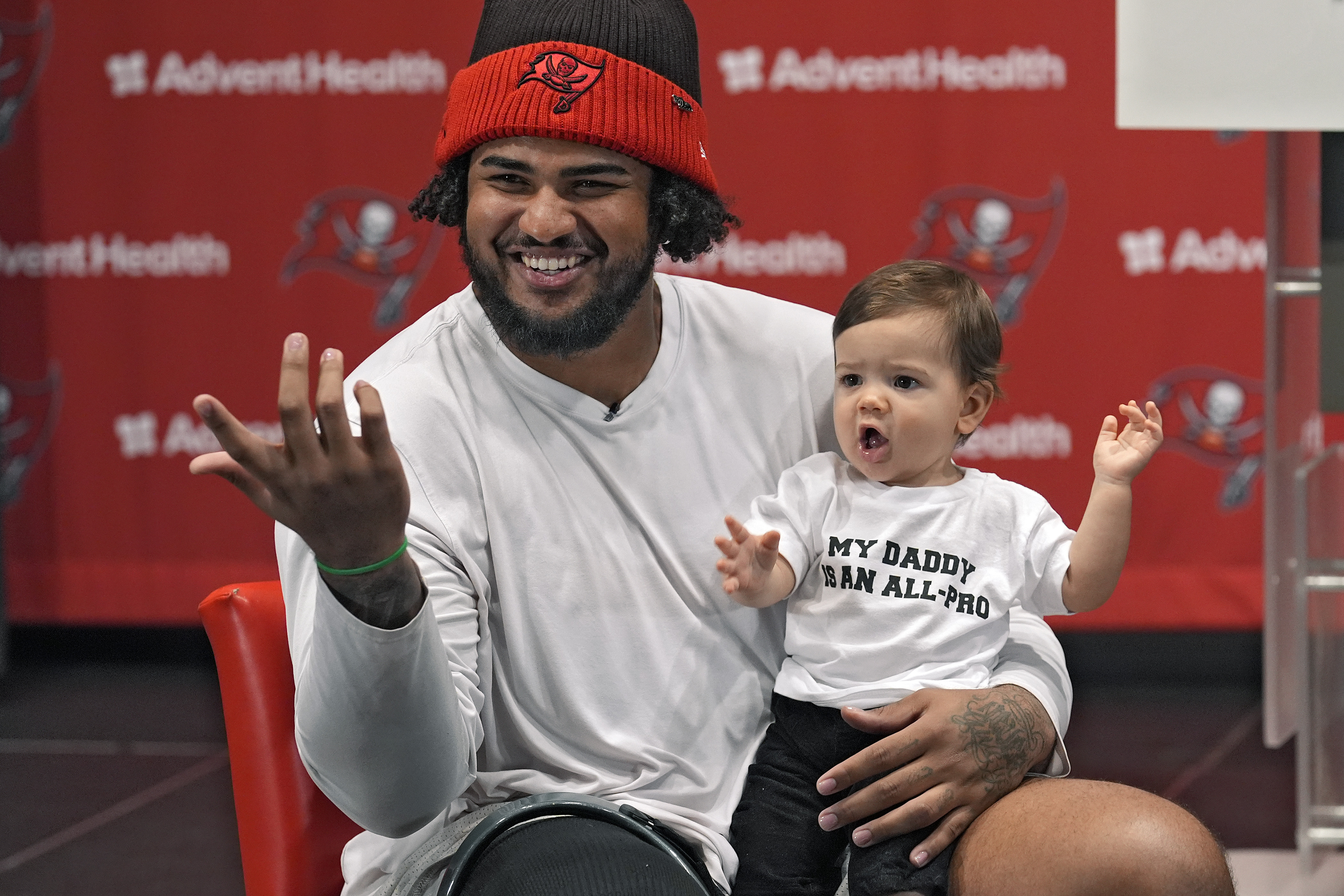 Tampa Bay Buccaneers offensive lineman Tristan Wirfs smiles as he holds his son Julius during an NFL football news conference Thursday, Jan. 9, 2025, in Tampa, Fla. Wirfs has been named to the AP All-Pro football team. (AP Photo/Chris O'Meara)