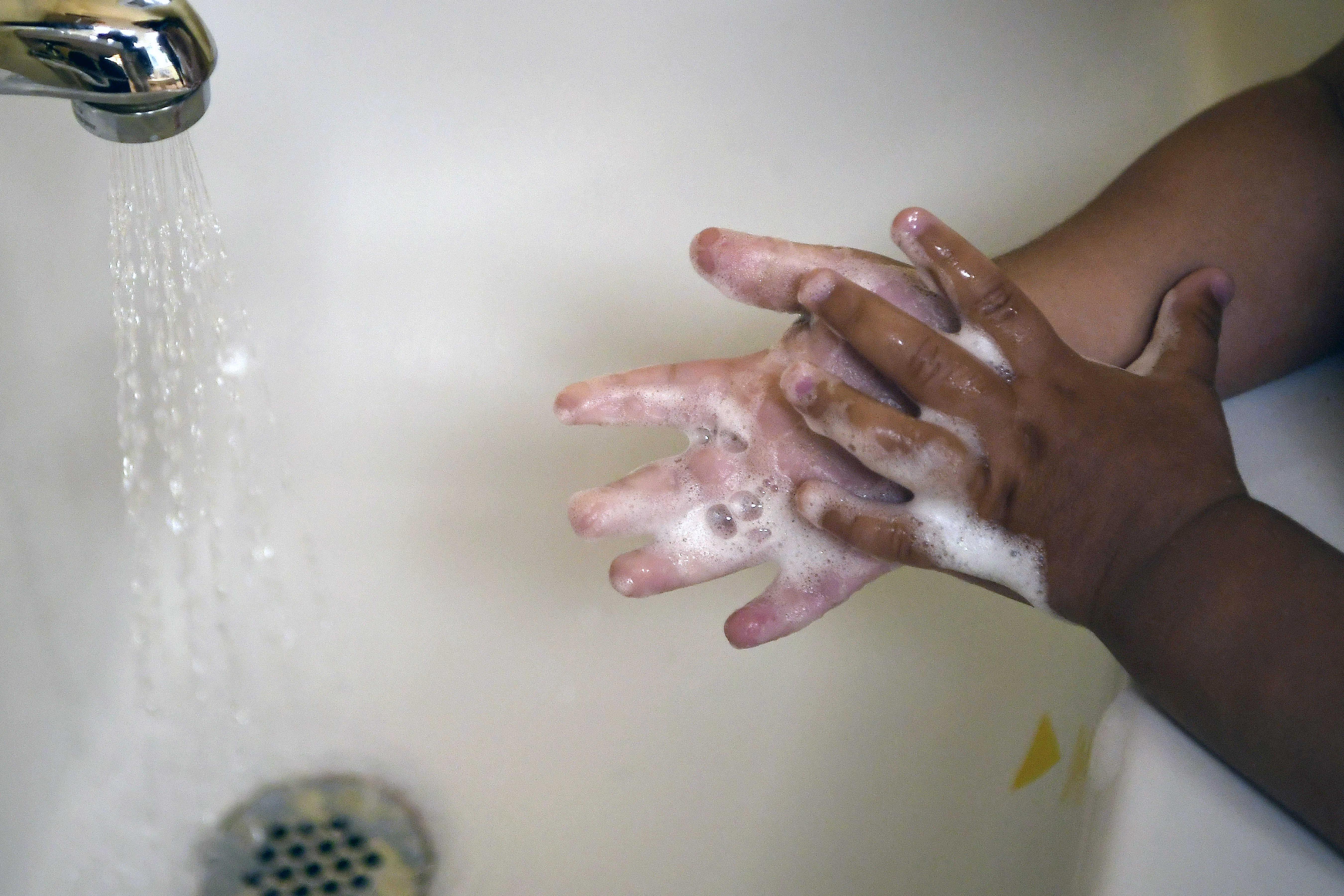 FILE - A child washes her hands at a day care center in Connecticut on Thursday Aug. 27, 2020. (AP Photo/Jessica Hill, File)