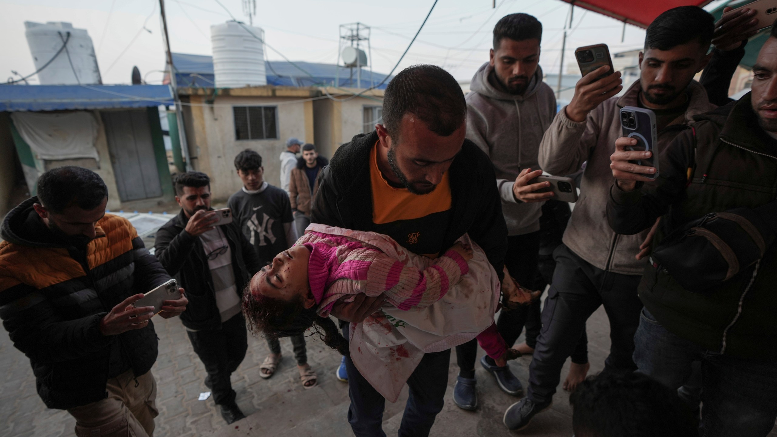 The body of Dima Eid, 5, who was killed in an Israeli airstrike, is brought to Al-Aqsa Hospital in Deir Al-Balah, Gaza, Saturday, Jan. 11, 2025. (AP Photo/Abdel Kareem Hana)