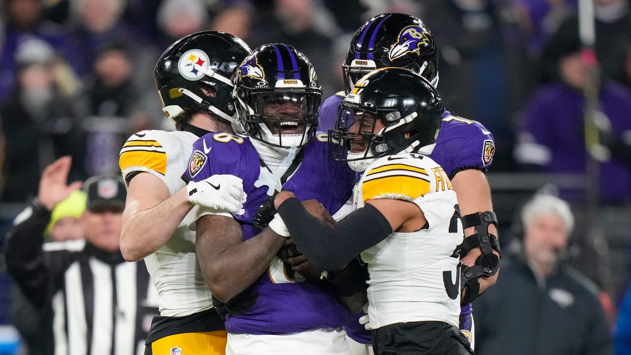 Baltimore Ravens quarterback Lamar Jackson, center, reacts after being stopped by Pittsburgh Steelers safety Minkah Fitzpatrick, right, during the first half of an NFL wild-card playoff football game, Saturday, Jan. 11, 2025, in Baltimore. (AP Photo/Stephanie Scarbrough)