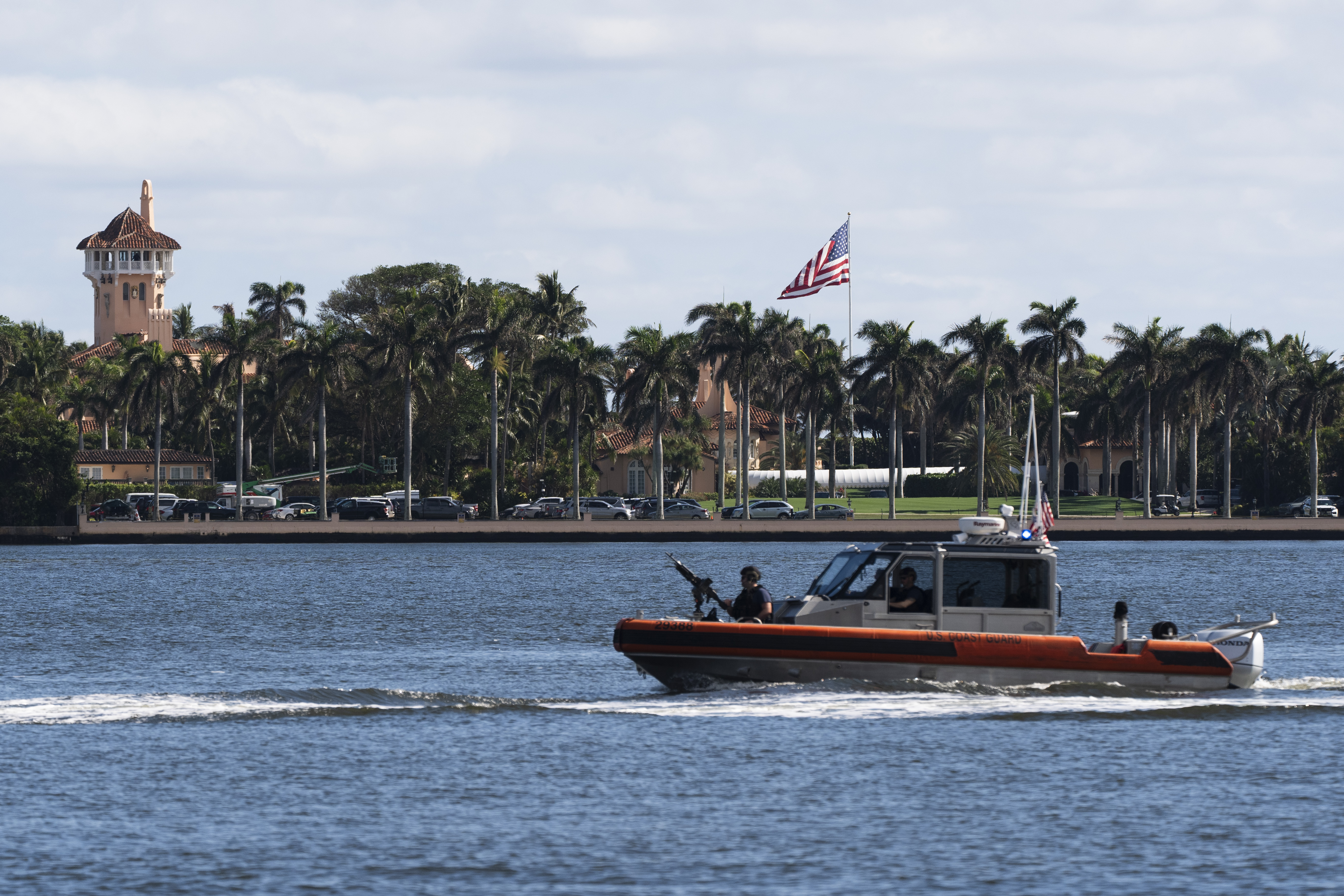 The U.S. flag is shown at the Mar-a-Lago compound in Palm Beach, Fla., while a U.S. Coast Guard boat patrols around the vicinity, Monday, Jan. 13, 2025. U.S. flags at President-elect Donald Trump's private Mar-a-Lago club are back to flying at full height. Flags are supposed to fly at half-staff through the end of January out of respect for former President Jimmy Carter, who died Dec. 29. (AP Photo/Manuel Balce Ceneta)