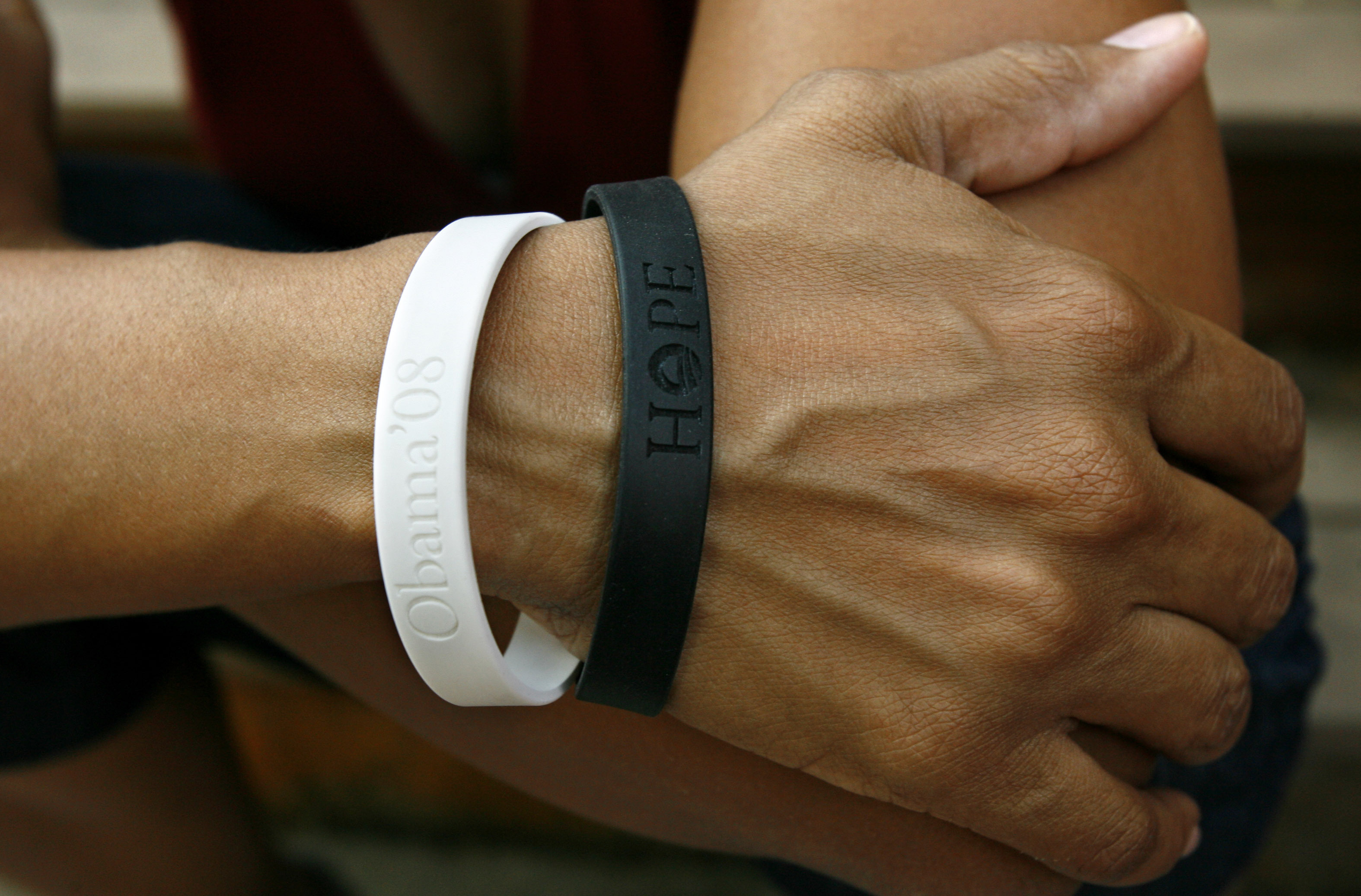 FILE - Rachel Lerman wears two bracelets supporting Sen. Barack Obama's candidacy for President, at her home in Washington, June 11, 2008. (AP Photo/Jacquelyn Martin, File)