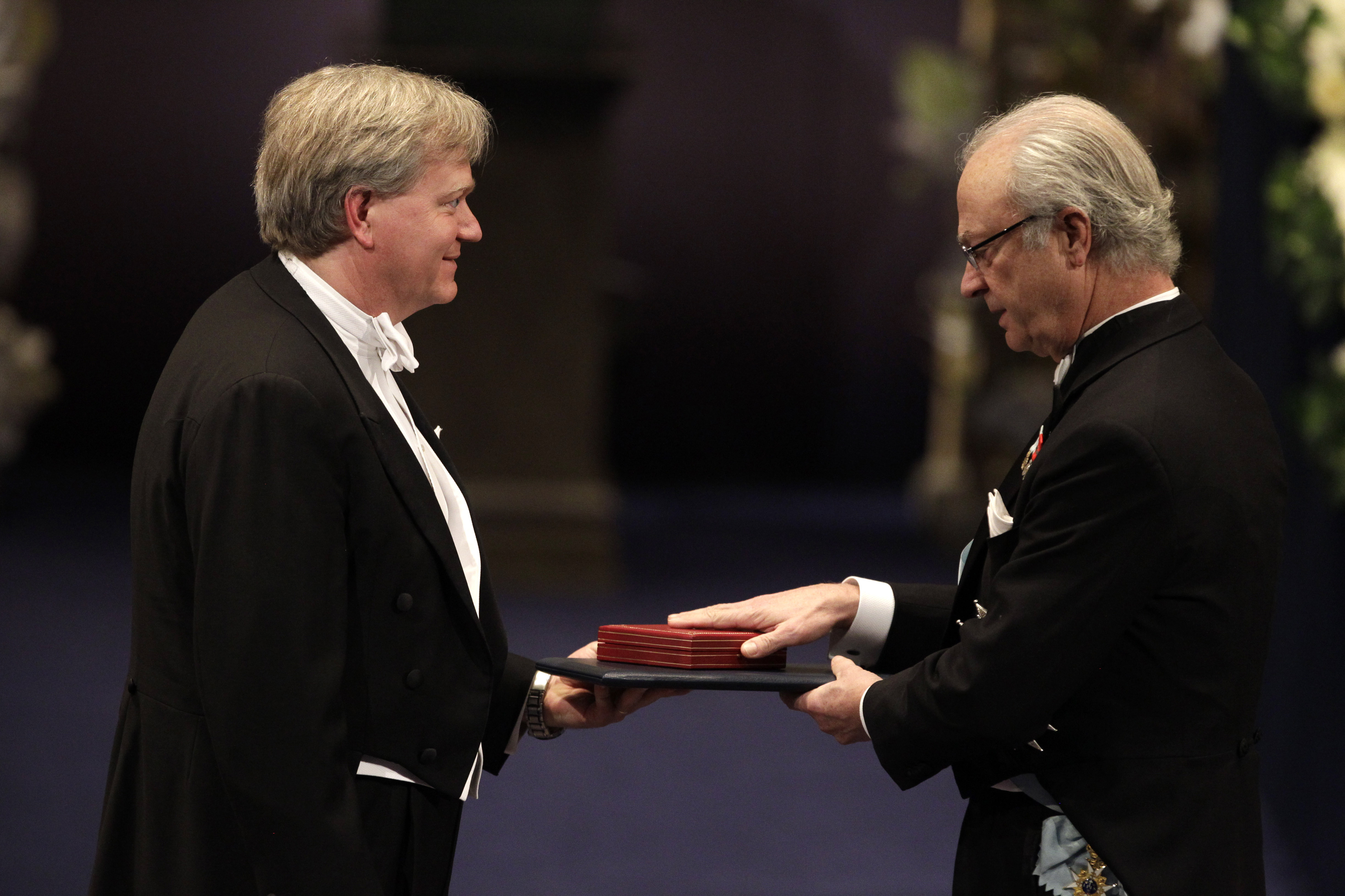 FILE - The 2011 Nobel Prize Laureate for Physics Dr Brian P. Schmidt from Australia receives his Nobel Prize from Sweden's King Carl XVI Gustaf, right, during the Nobel Prize award ceremony at the Stockholm Concert Hall in Stockholm, Sweden, Dec. 10, 2011. (AP Photo/Matt Dunham, File)