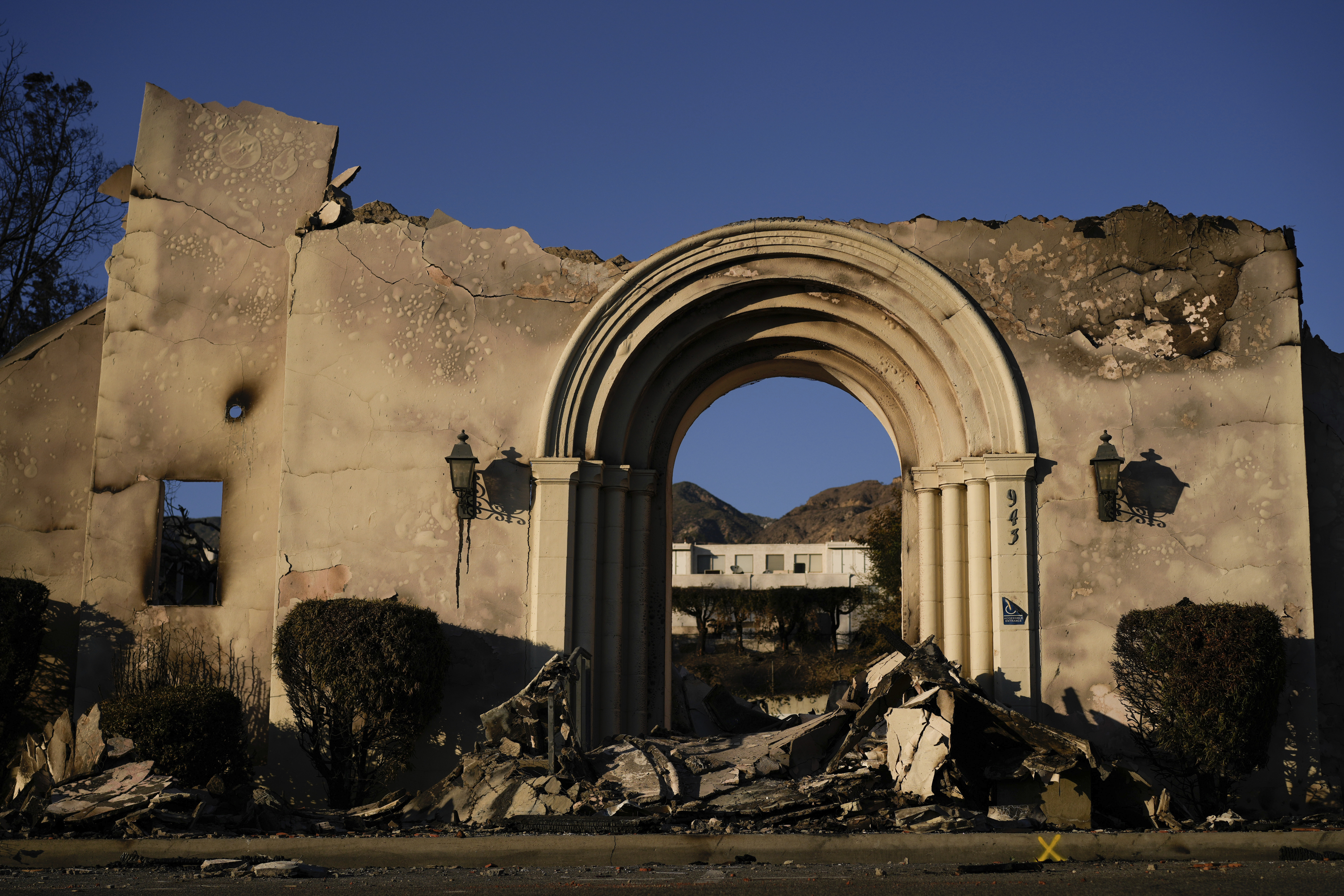 The facade of the Altadena Community Church stands amidst damage from the Eaton Fire on Monday, Jan. 13, 2025, in Altadena, Calif. (AP Photo/Carolyn Kaster)