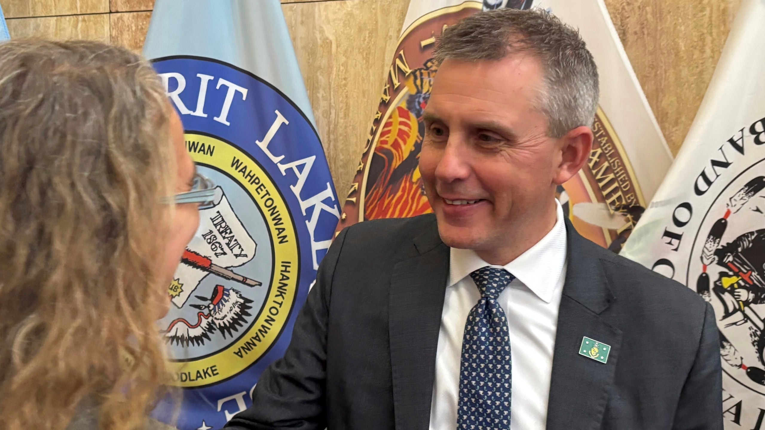 North Dakota Republican Gov. Kelly Armstrong, at right, greets state Rep. Dori Hauck in a receiving line following his State of the State address on Tuesday, Jan. 7, 2025, at the state Capitol in Bismarck, N.D. (AP Photo/Jack Dura)