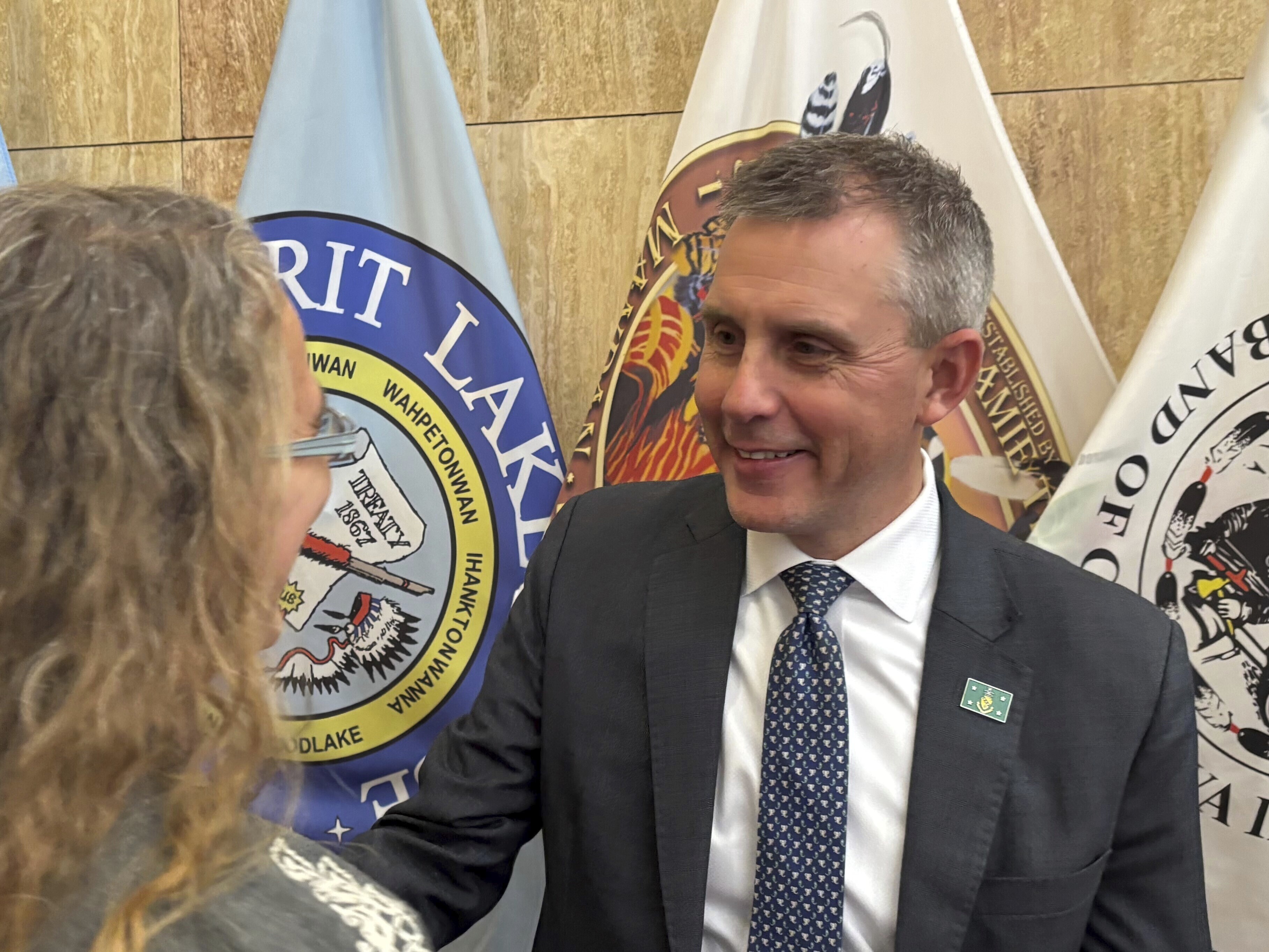 North Dakota Republican Gov. Kelly Armstrong, at right, greets state Rep. Dori Hauck in a receiving line following his State of the State address on Tuesday, Jan. 7, 2025, at the state Capitol in Bismarck, N.D. (AP Photo/Jack Dura)