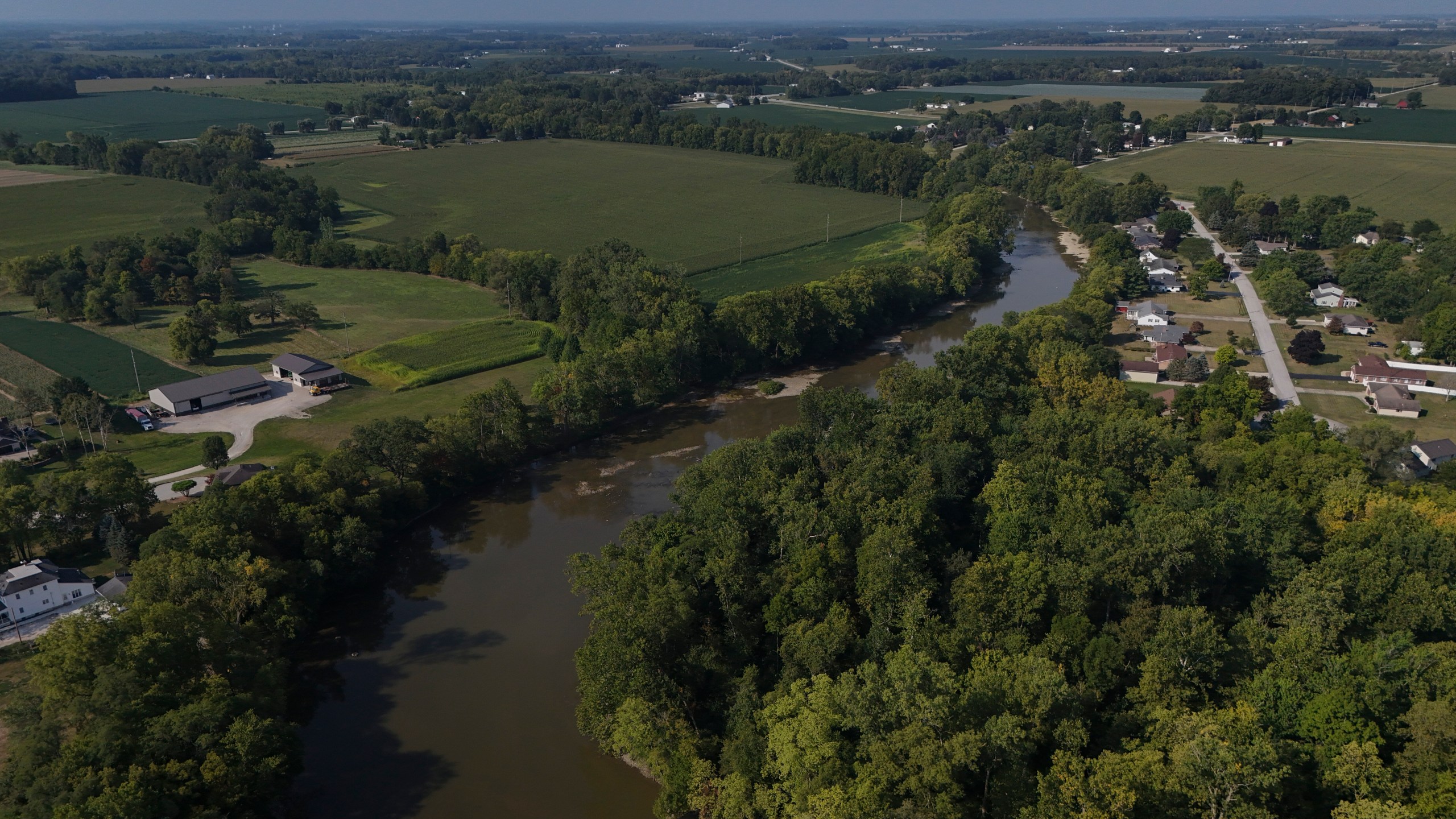 FILE - Water flows down the Sandusky River between farms, Aug. 26, 2024, in Fremont, Ohio. (AP Photo/Joshua A. Bickel, File)