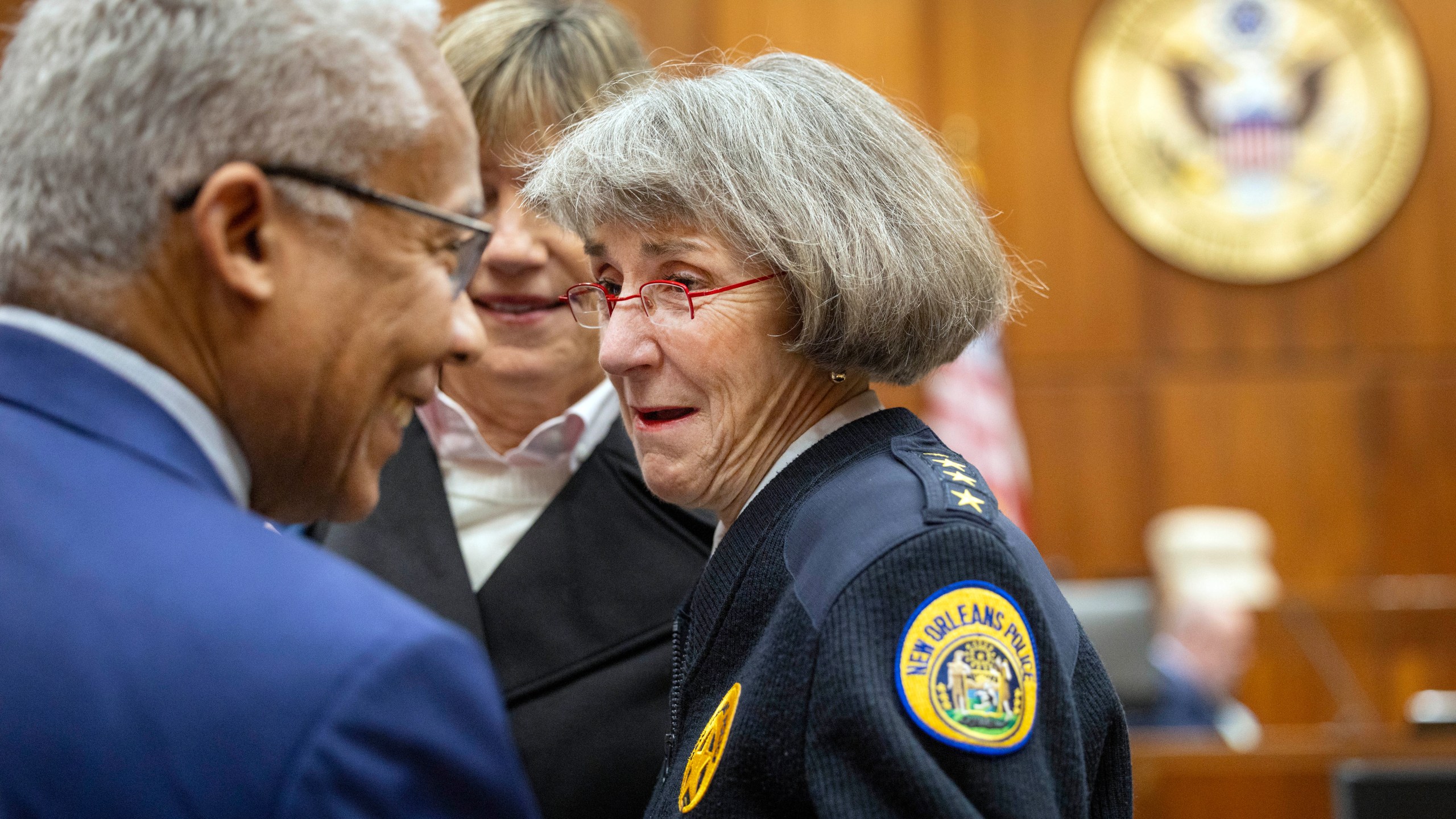 New Orleans Police Superintendent Anne Kirkpatrick, center, chats with U.S. Justice Department deputy monitor David Douglass, left, in Federal Court, Tuesday, Jan. 14, 2025, in New Orleans, after a judge ruled the New Orleans Police Department can begin the process of ending longstanding federal oversight. (Chris Granger/The Times-Picayune/The New Orleans Advocate via AP)