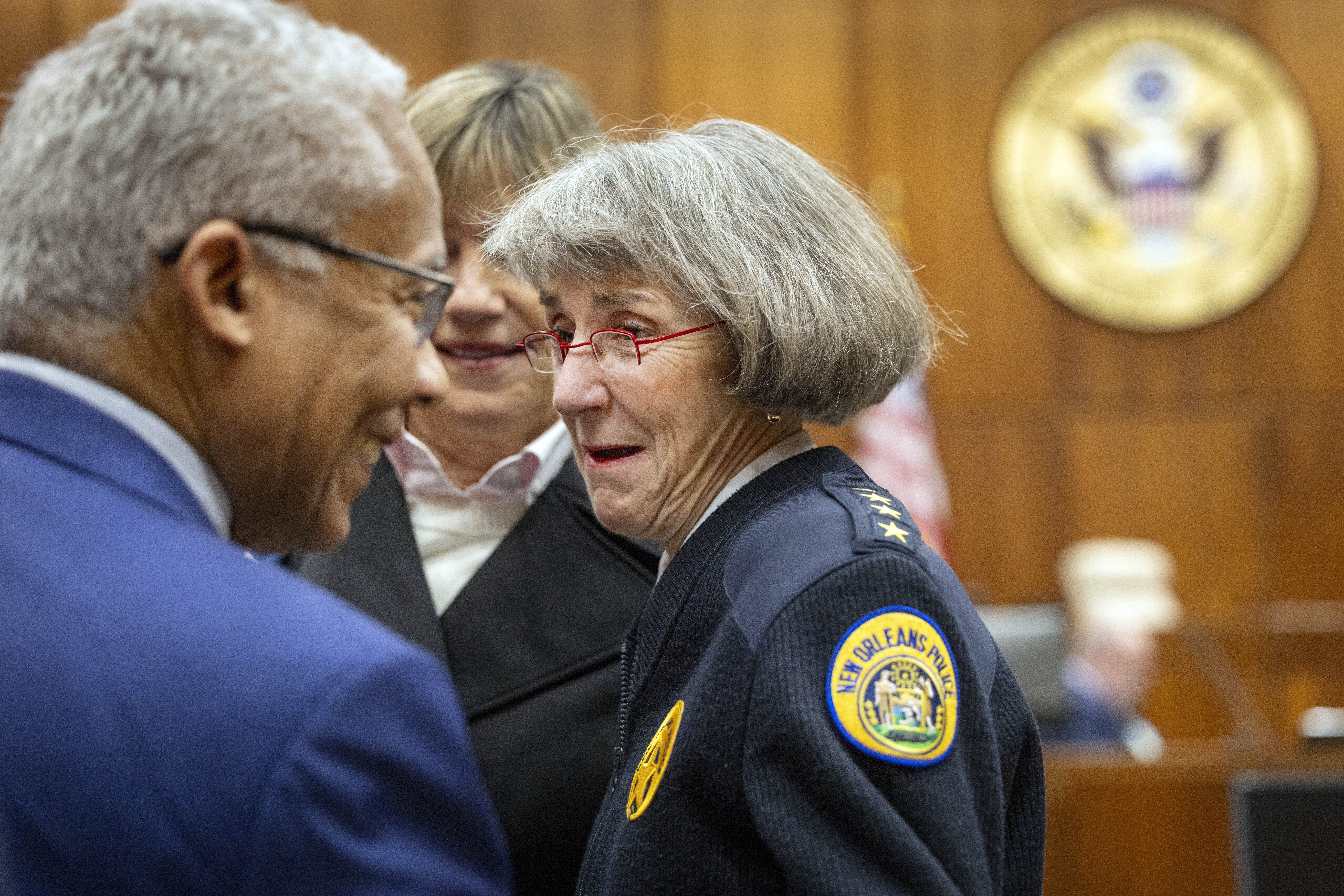 New Orleans Police Superintendent Anne Kirkpatrick, center, chats with U.S. Justice Department deputy monitor David Douglass, left, in Federal Court, Tuesday, Jan. 14, 2025, in New Orleans, after a judge ruled the New Orleans Police Department can begin the process of ending longstanding federal oversight. (Chris Granger/The Times-Picayune/The New Orleans Advocate via AP)