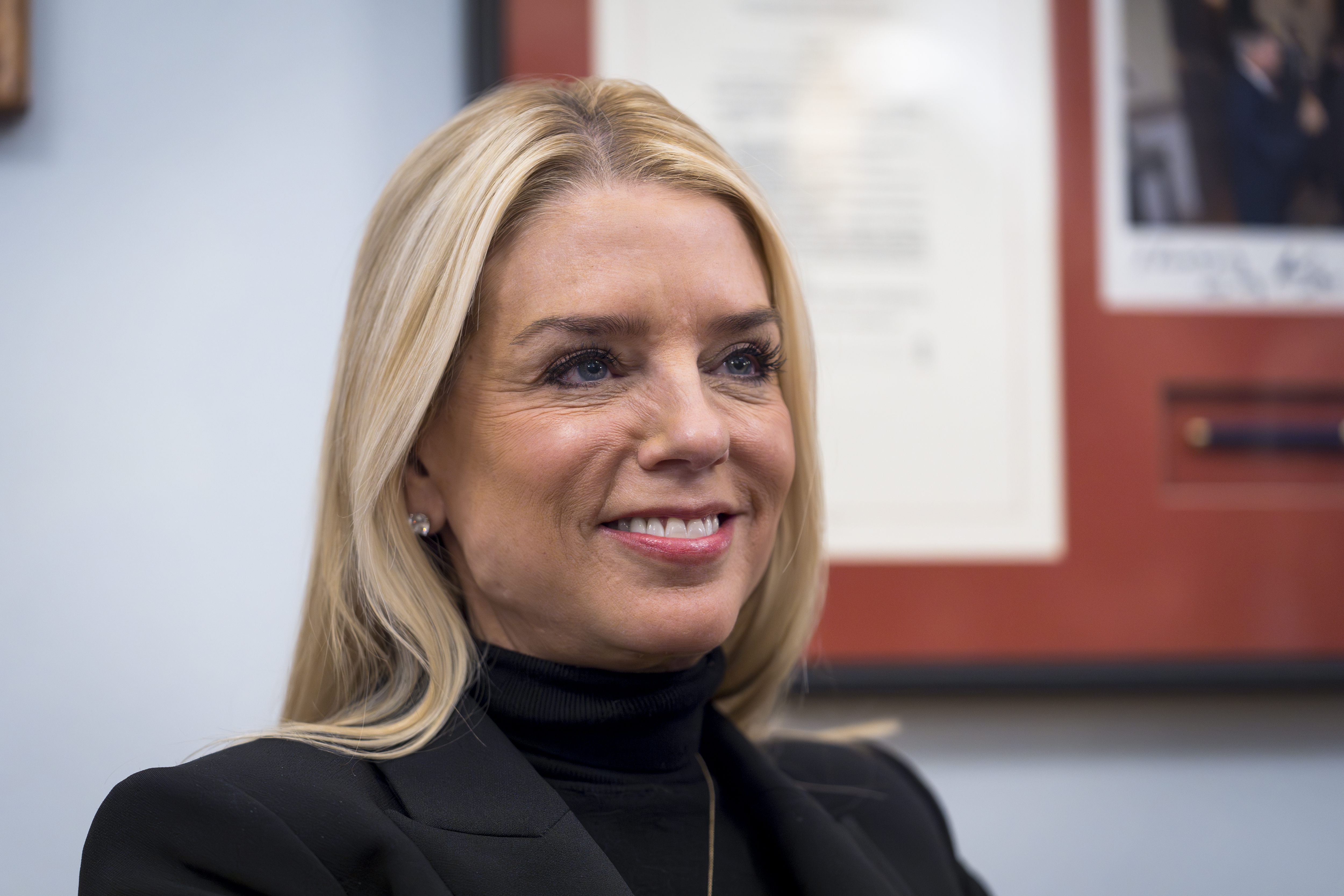 FILE - Pam Bondi, President-elect Donald Trump's nominee for Attorney General, listens during a meeting with Sen. Lindsey Graham, R-S.C., at the Capitol in Washington, Dec. 2, 2024. (AP Photo/J. Scott Applewhite, File)