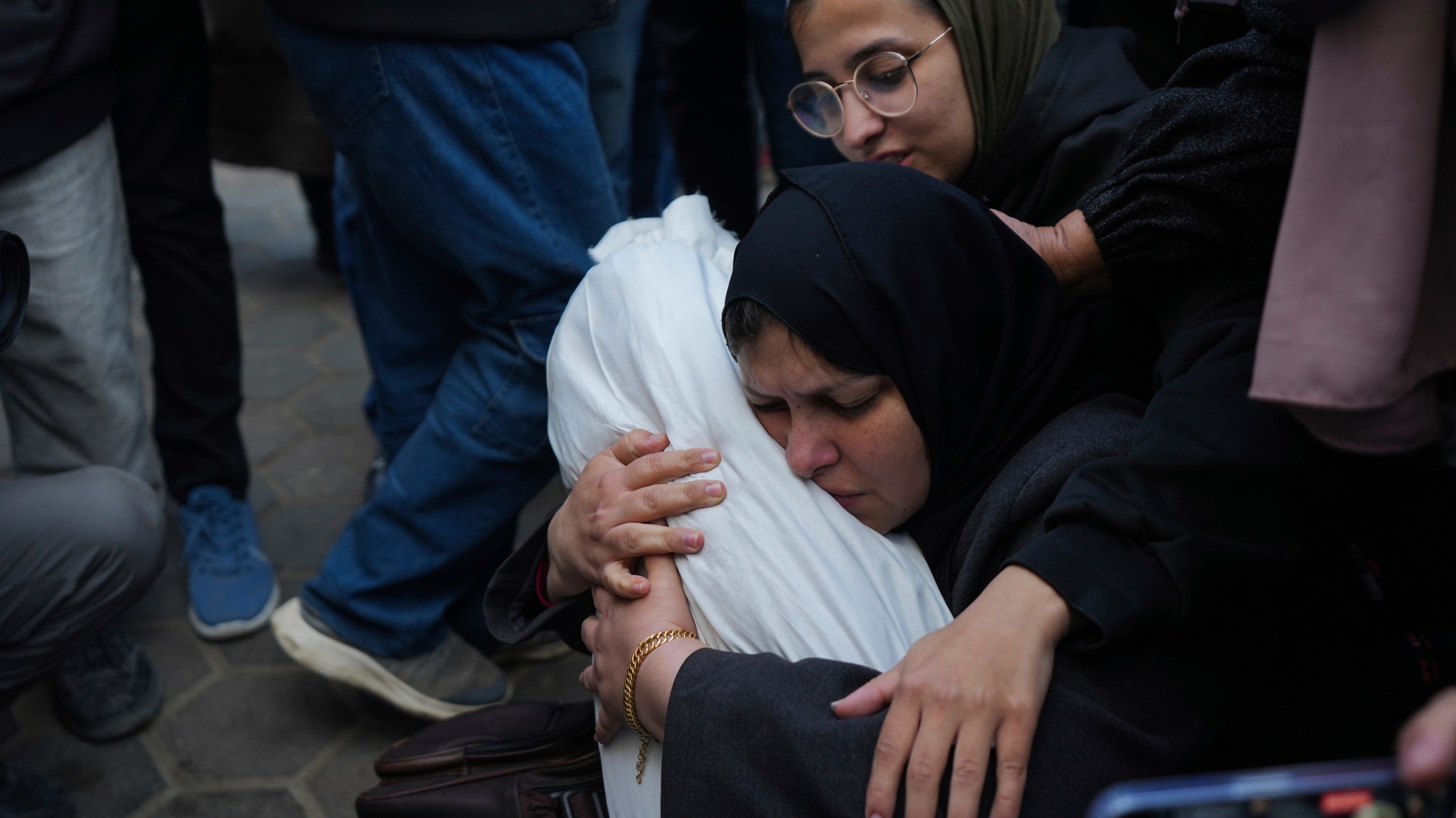 Hanan Shaqoura embraces the body of her son, Mohammad, 7, who was killed in the Israeli bombardment of the Gaza Strip, during his funeral in Deir al-Balah, Wednesday, Jan. 15, 2025. (AP Photo/Abdel Kareem Hana)