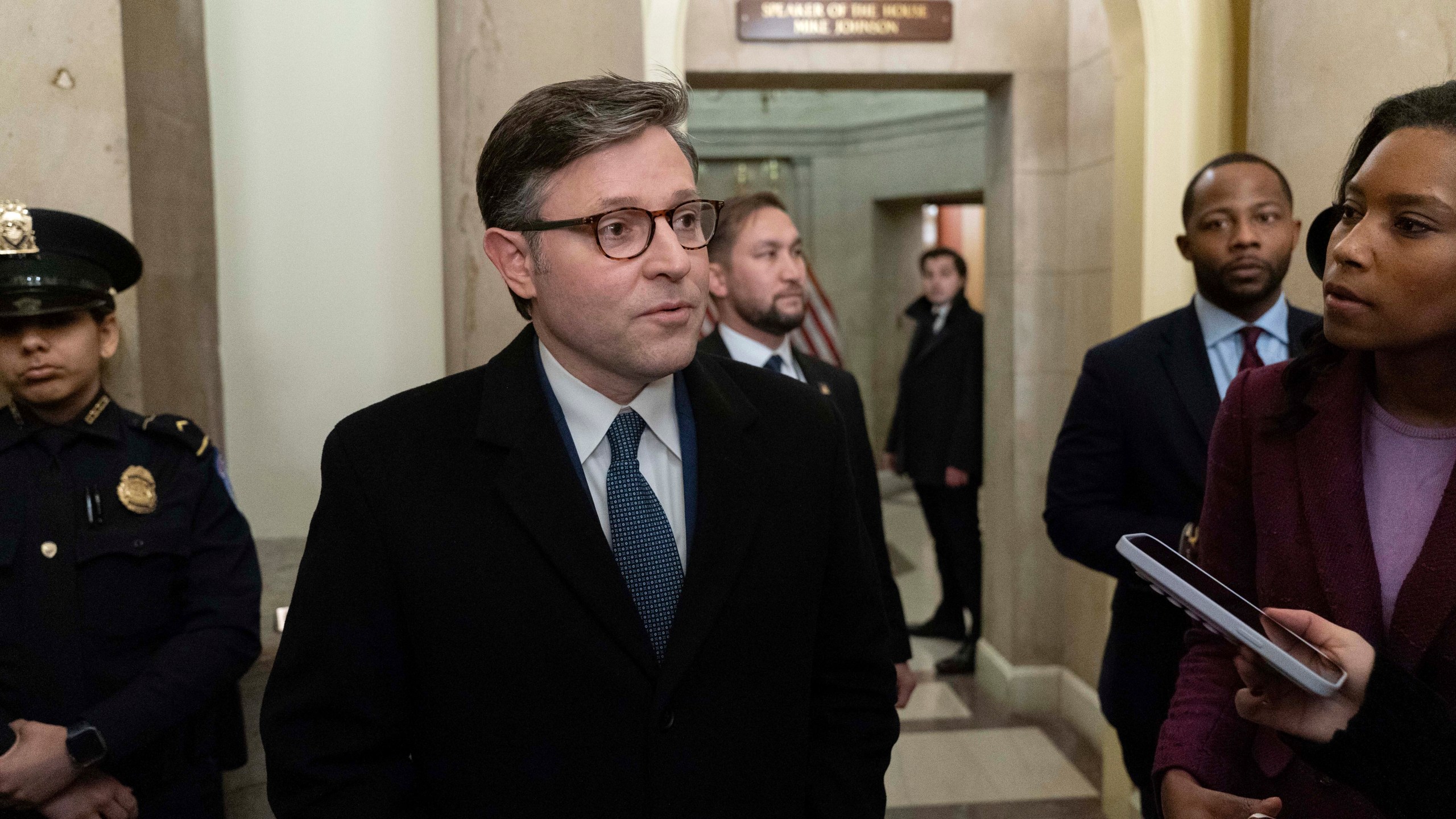 Speaker of the House Mike Johnson, R-La., talks to reporters on his way to his office ahead of a joint session of Congress to certify the votes from the Electoral College in the presidential election, in Washington, Monday, Jan. 6, 2025. (AP Photo/Jose Luis Magana)