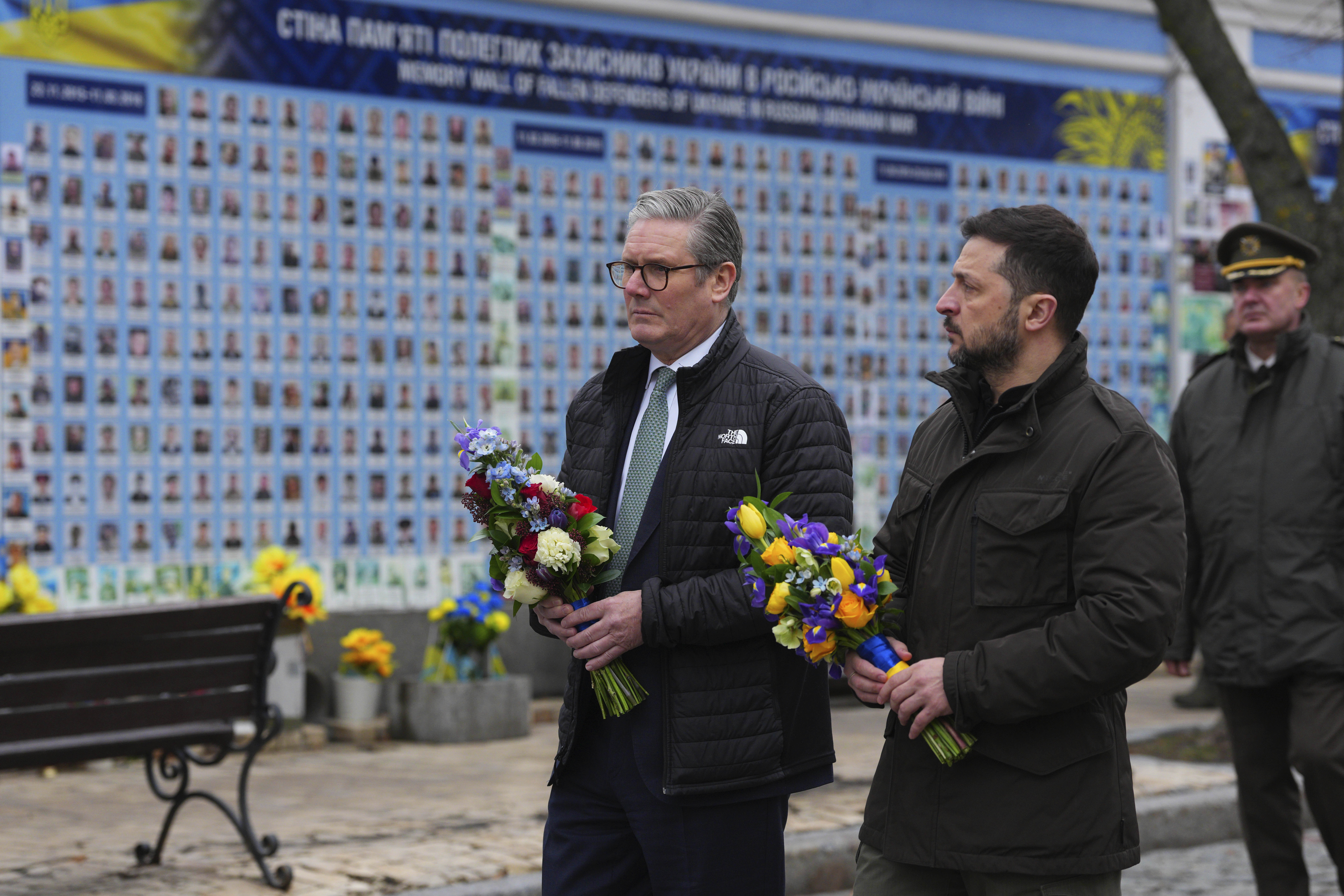 British Prime Minister Keir Starmer and Ukrainian President Volodymyr Zelenskyy arrive to lay wreaths at The Wall of Remembrance of the Fallen for Ukraine in Kyiv, Ukraine Thursday, Jan. 16, 2025. (Carl Court/Pool Photo via AP)