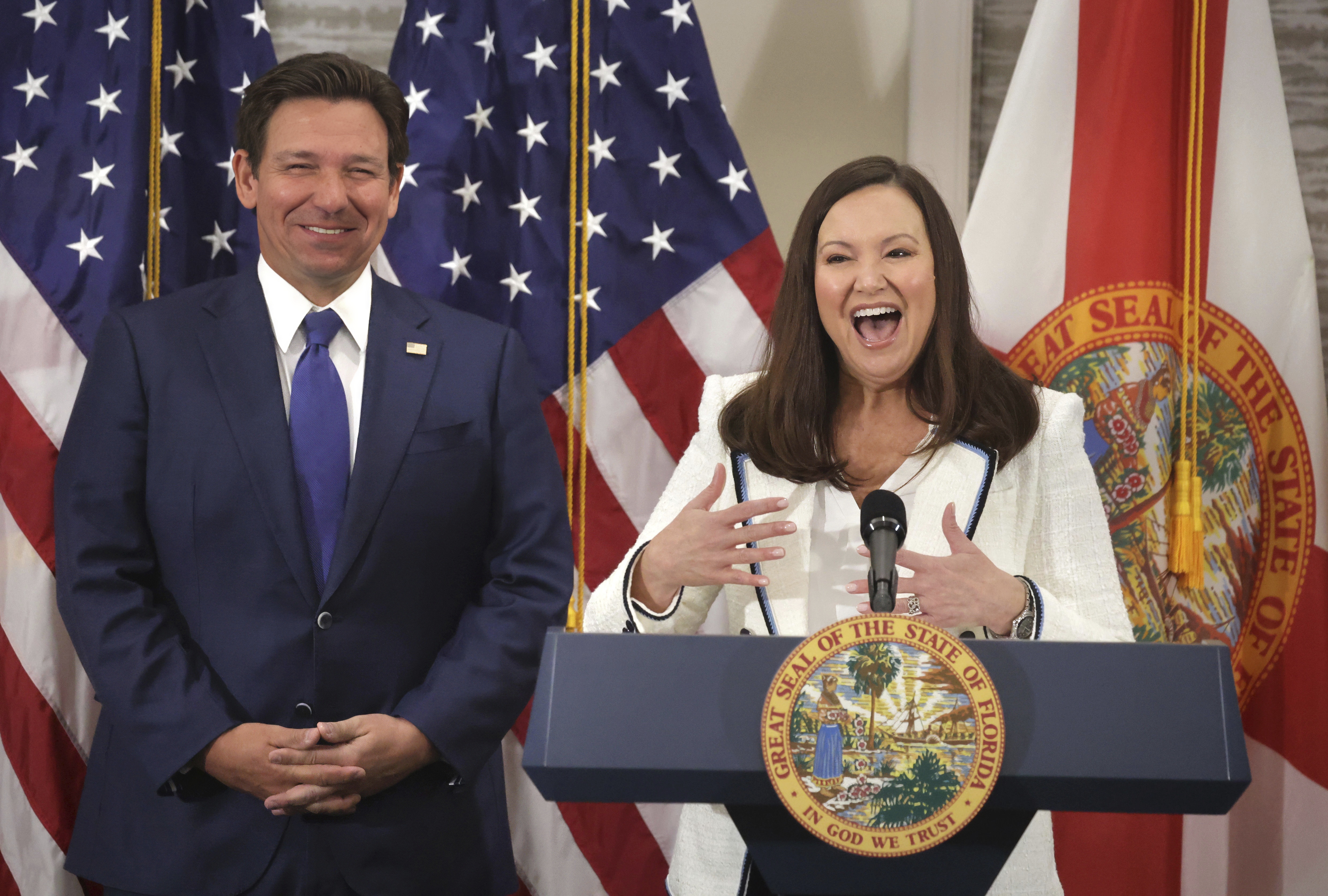 Florida Attorney General Ashley Moody responds to cheering supporters after Gov. Ron DeSantis, left, announced her appointment as U.S. senator to replace Marco Rubio, during a press conference at the Rosen Plaza Hotel in Orlando, Fla., Thursday, Jan. 16, 2024. (Joe Burbank/Orlando Sentinel via AP)