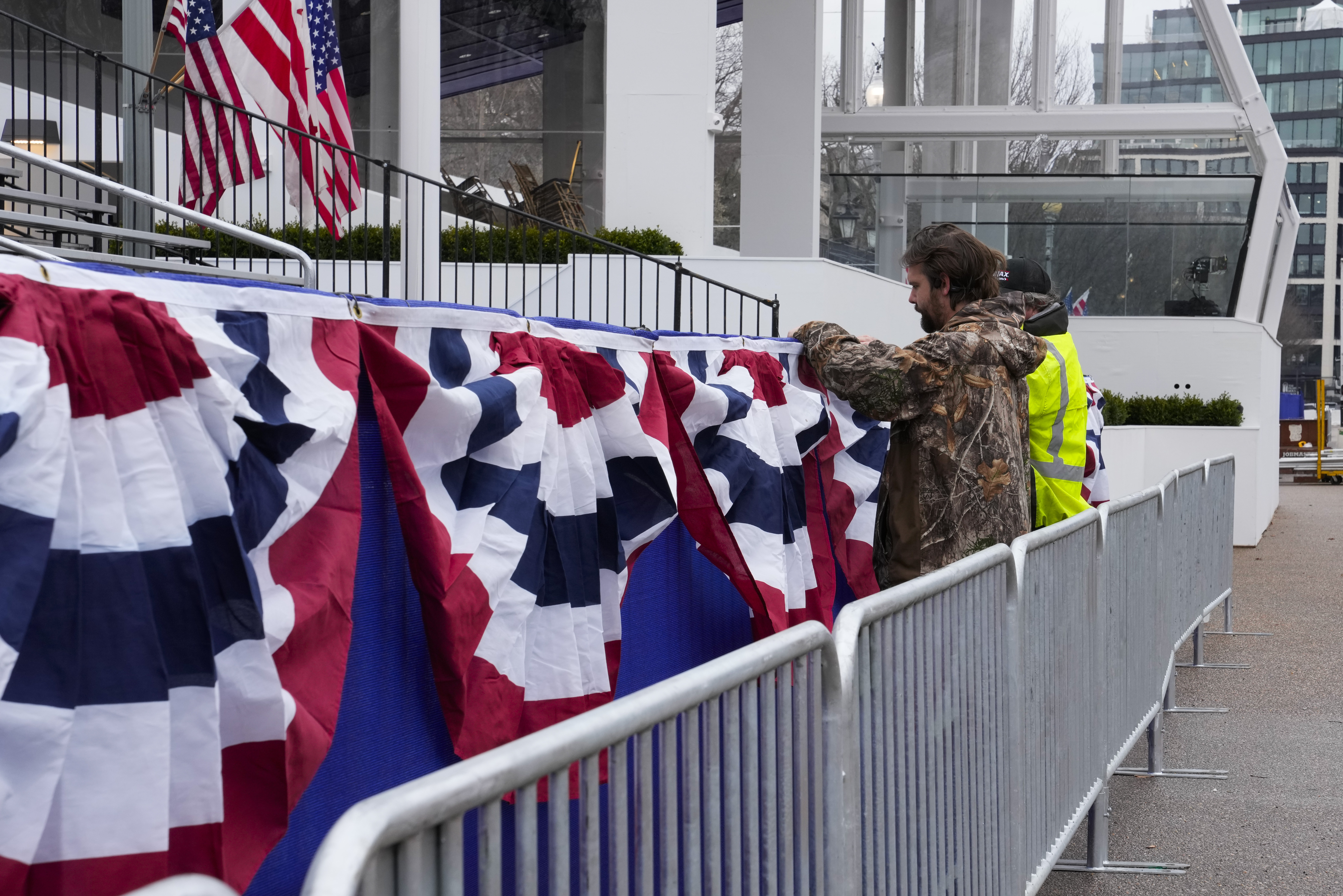 Work continues near the presidential reviewing stand on Pennsylvania Avenue outside the White House, Friday, Jan. 17, 2025, in Washington, ahead of President-elect Donald Trump's inauguration. (AP Photo/Jon Elswick)