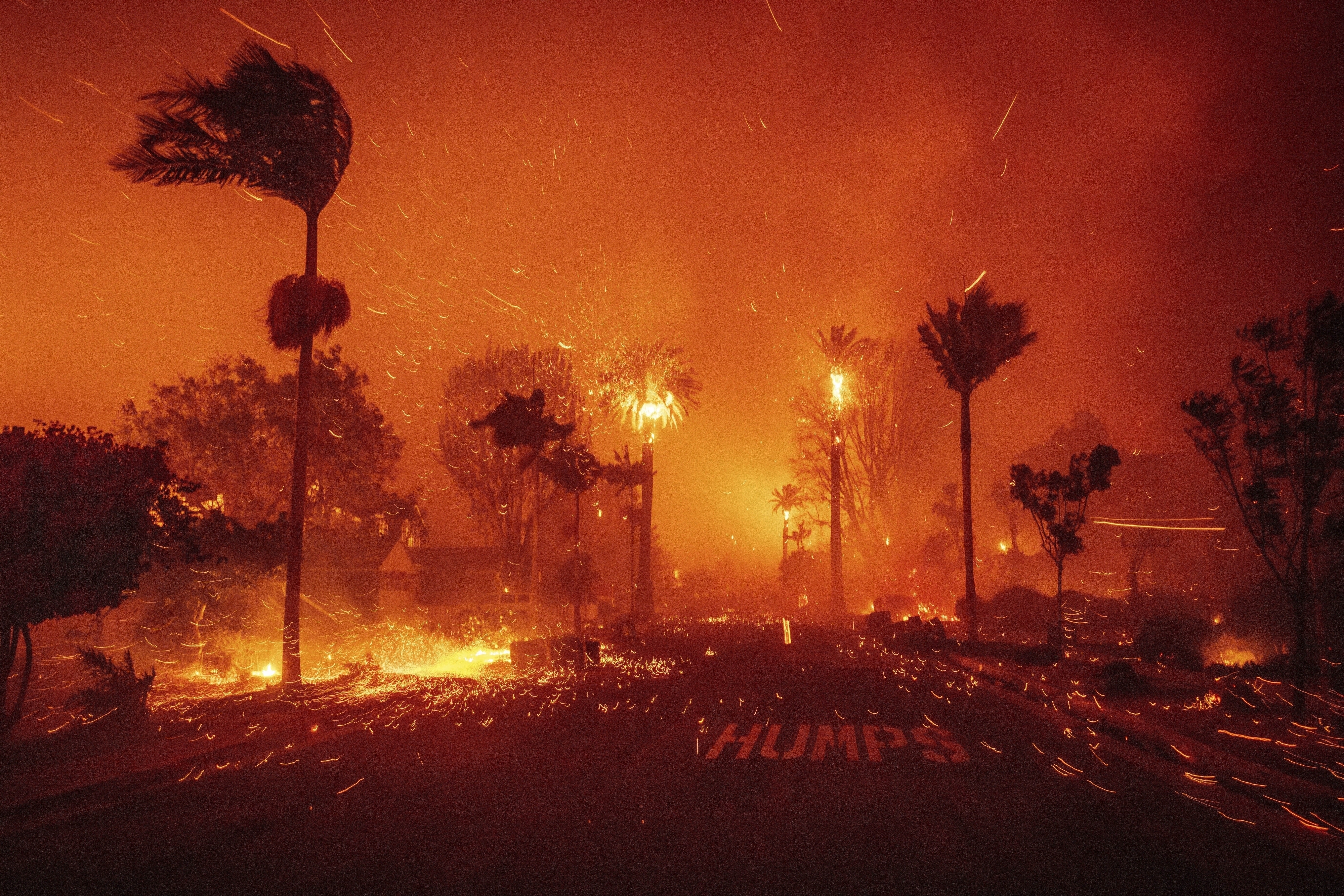 FILE - The Palisades Fire ravages a neighborhood amid high winds in the Pacific Palisades neighborhood of Los Angeles, Tuesday, Jan. 7, 2025. (AP Photo/Ethan Swope, File)