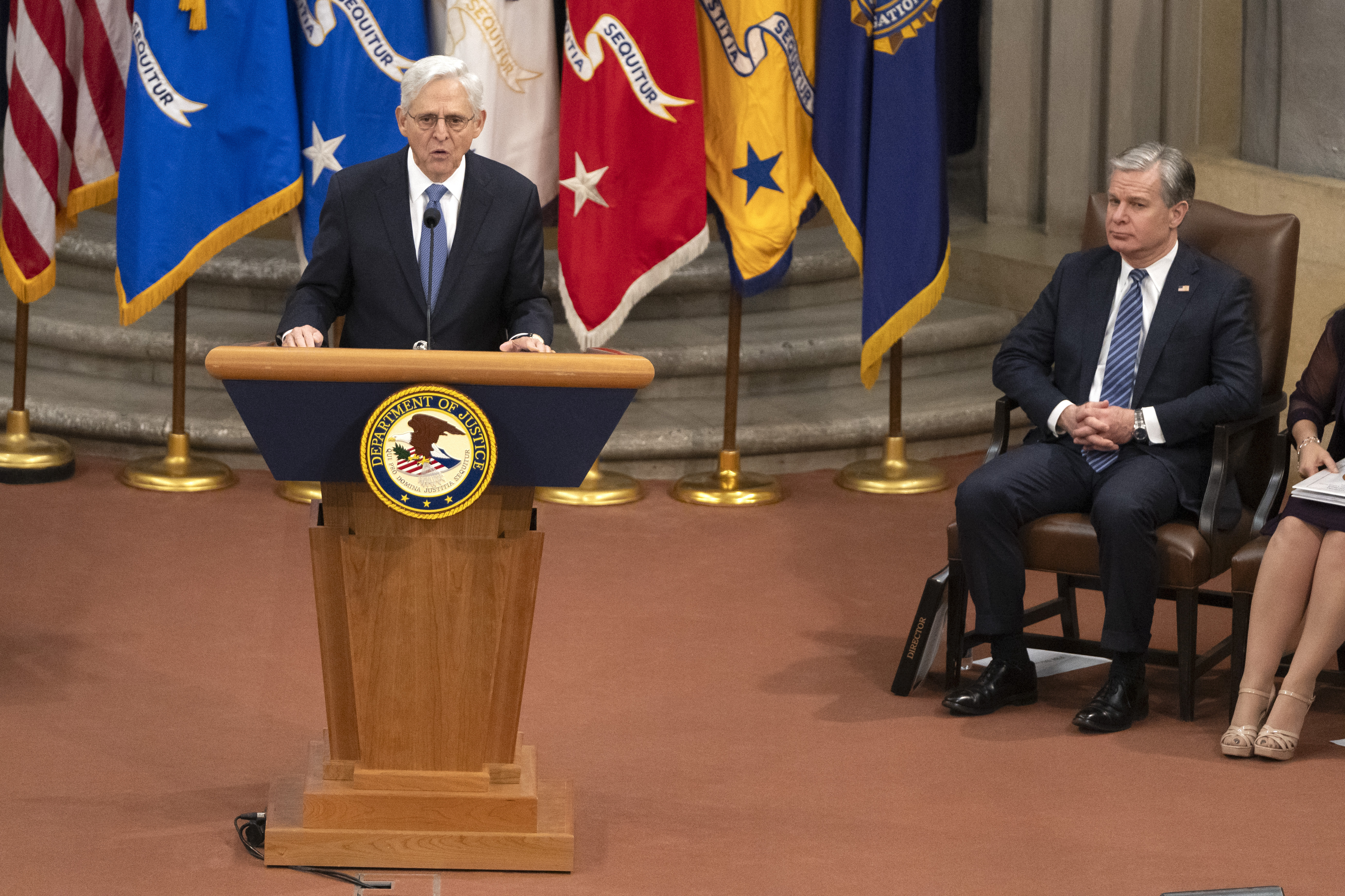 Attorney General Merrick Garland speaks as FBI Director Christopher Wray listens during a farewell ceremony at the Department of Justice, Thursday, Jan. 16, 2025, in Washington. (AP Photo/Mark Schiefelbein)