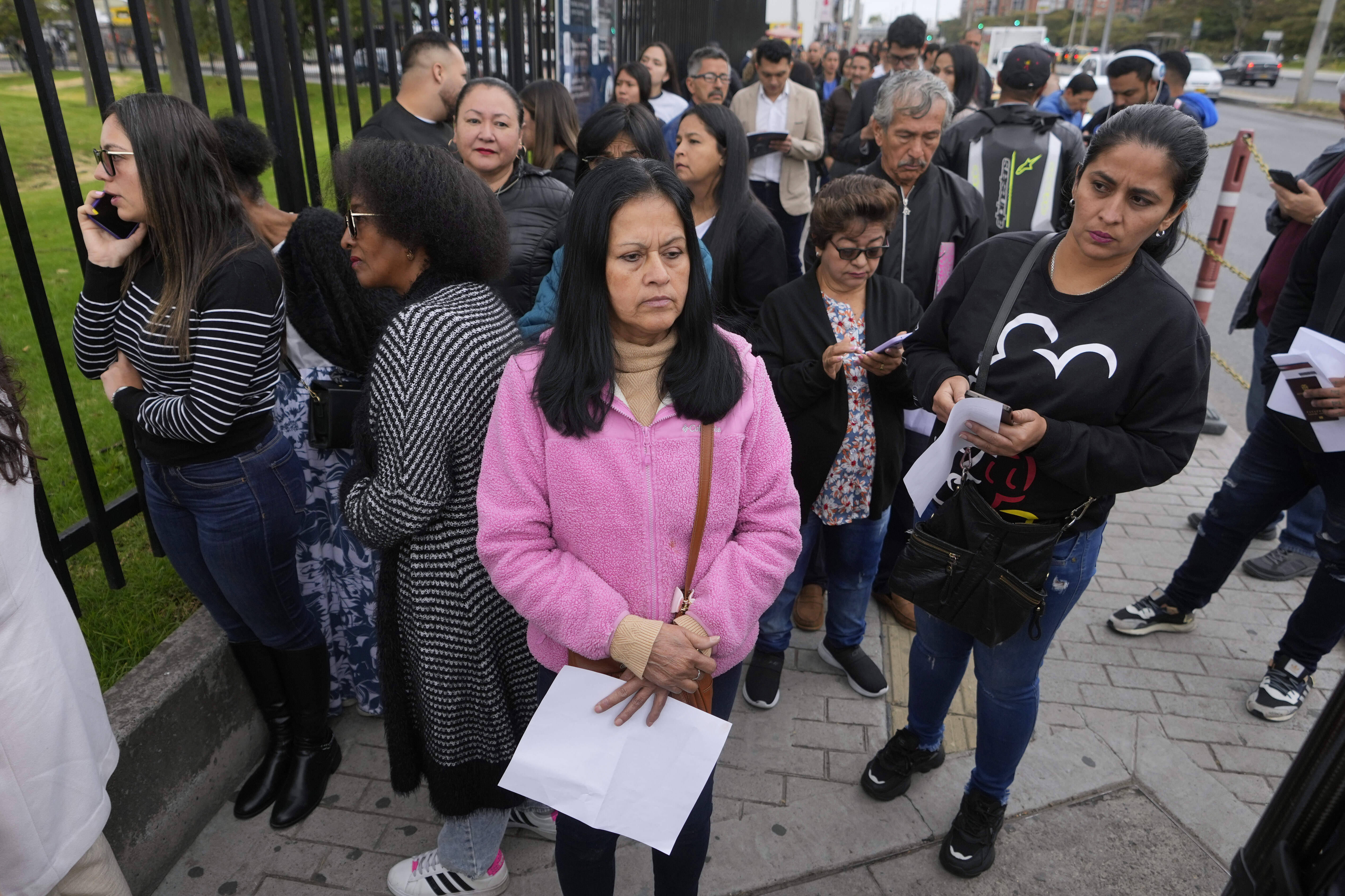 Gloria Camacho holds a notification stating her visa appointment was canceled, due to Colombian President Gustavo Petro's refusal to accept repatriation flights of Colombian citizens from the U.S., outside the U.S. embassy in Bogota, Colombia, Monday, Jan. 27, 2025. (AP Photo/Fernando Vergara)