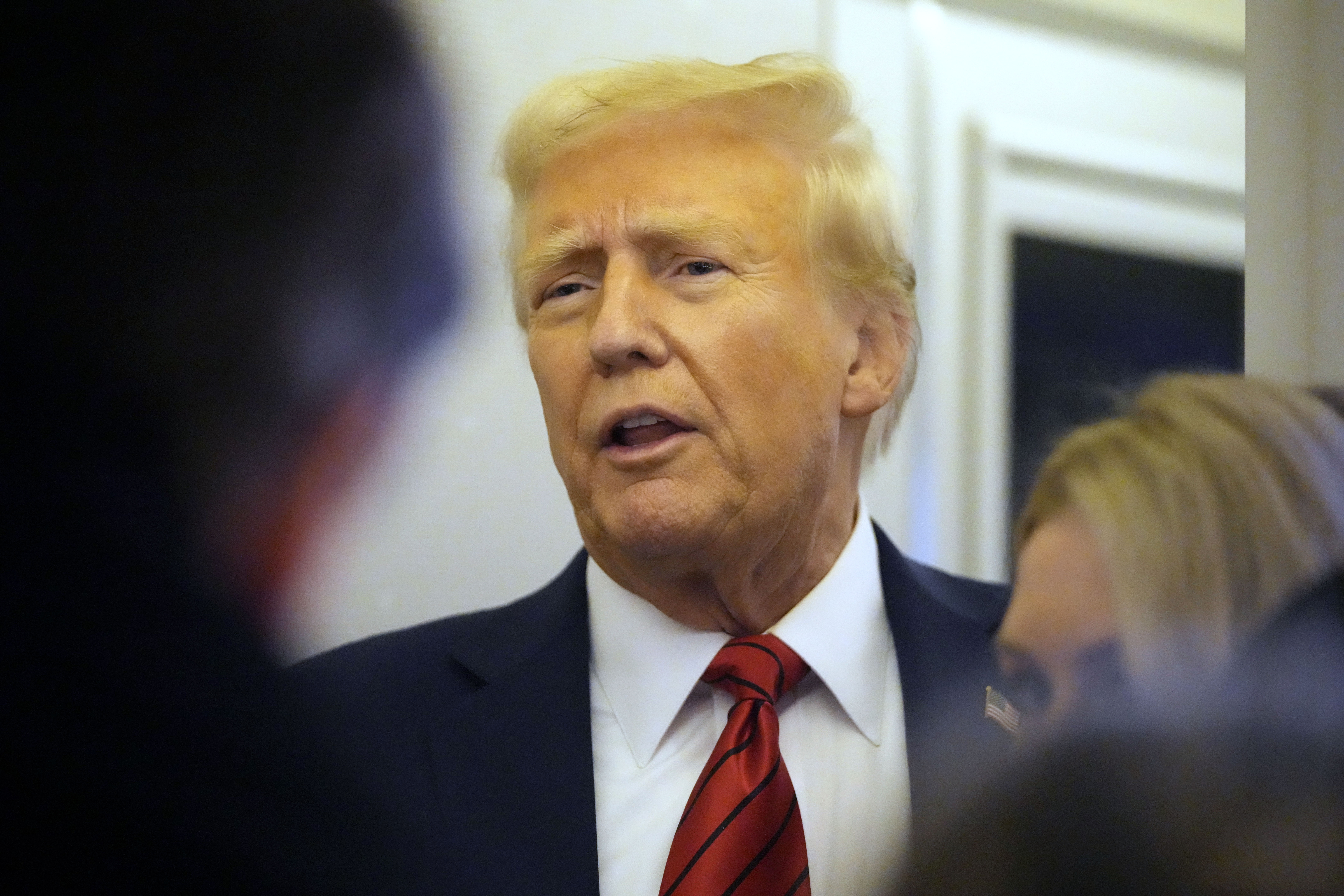 President Donald Trump speaks to reporters aboard Air Force One en route from Miami to Joint Base Andrews, Md., Monday, Jan. 27, 2025. (AP Photo/Mark Schiefelbein)