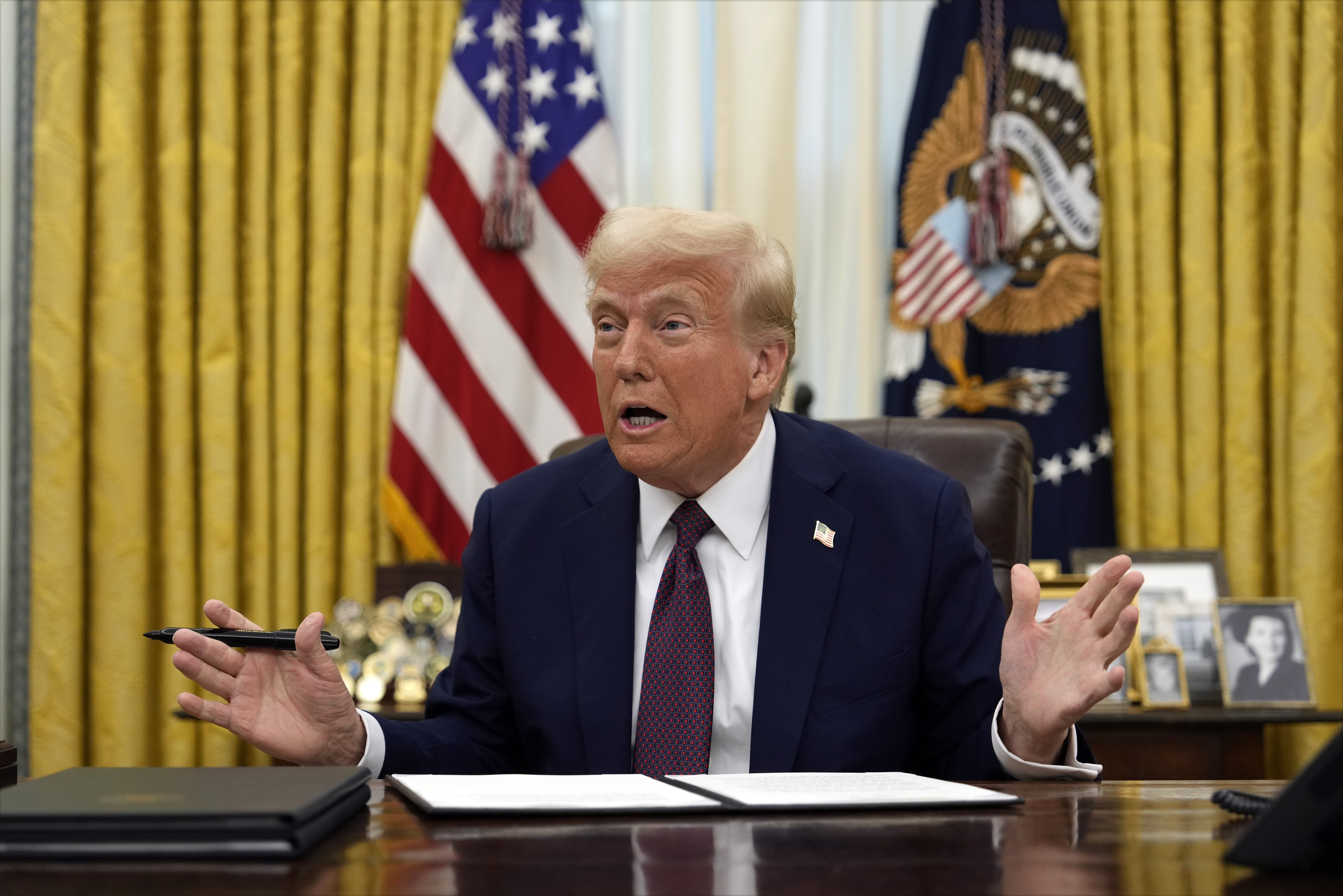 President Donald Trump talks as he signs an executive order giving federal recognition to the Limbee Tribe of North Carolina, in the Oval Office of the White House, Thursday, Jan. 23, 2025, in Washington. (AP Photo/Ben Curtis)