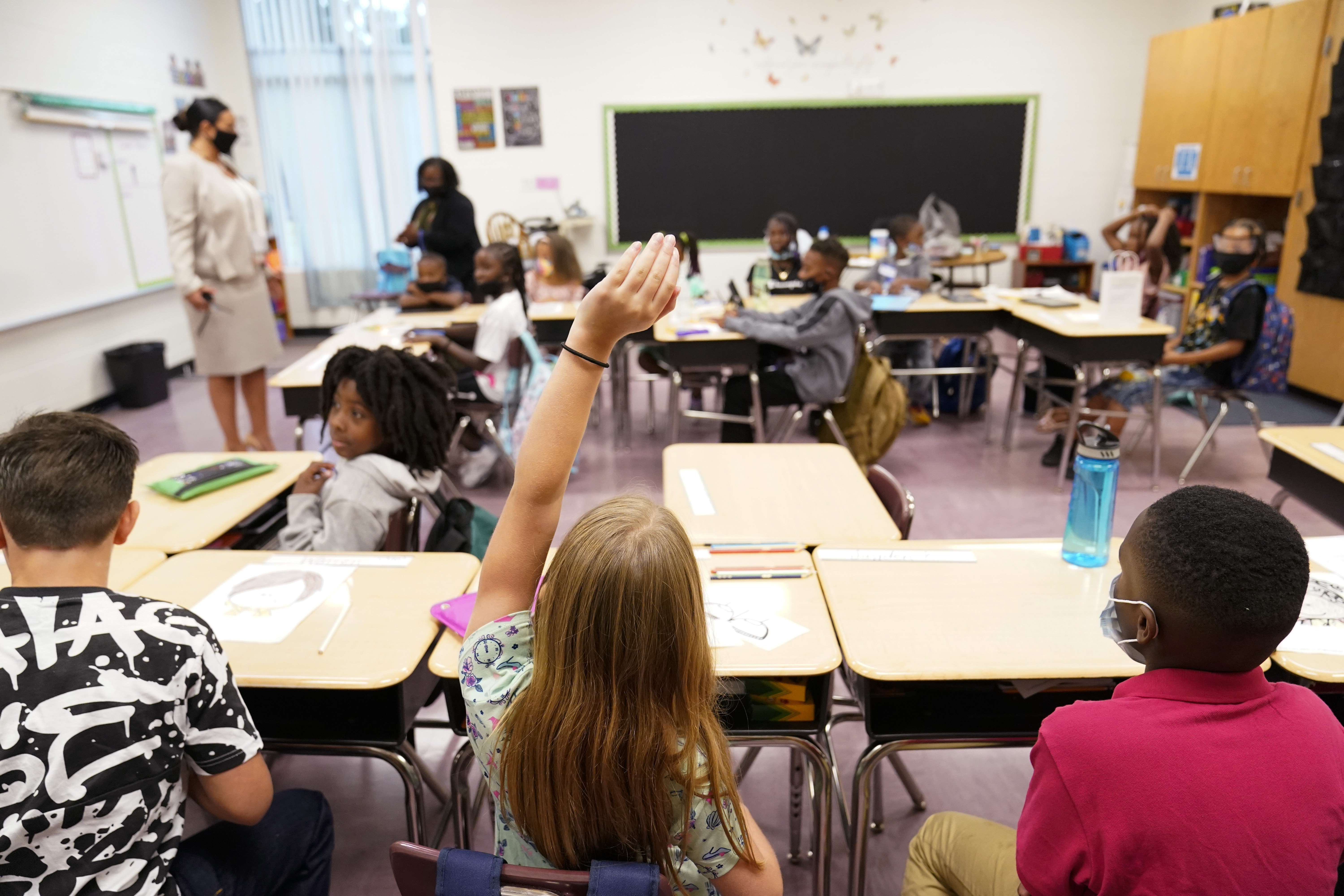 FILE - A student raises their hand in a classroom at Tussahaw Elementary school Aug. 4, 2021, in McDonough, Ga. (AP Photo/Brynn Anderson, File)