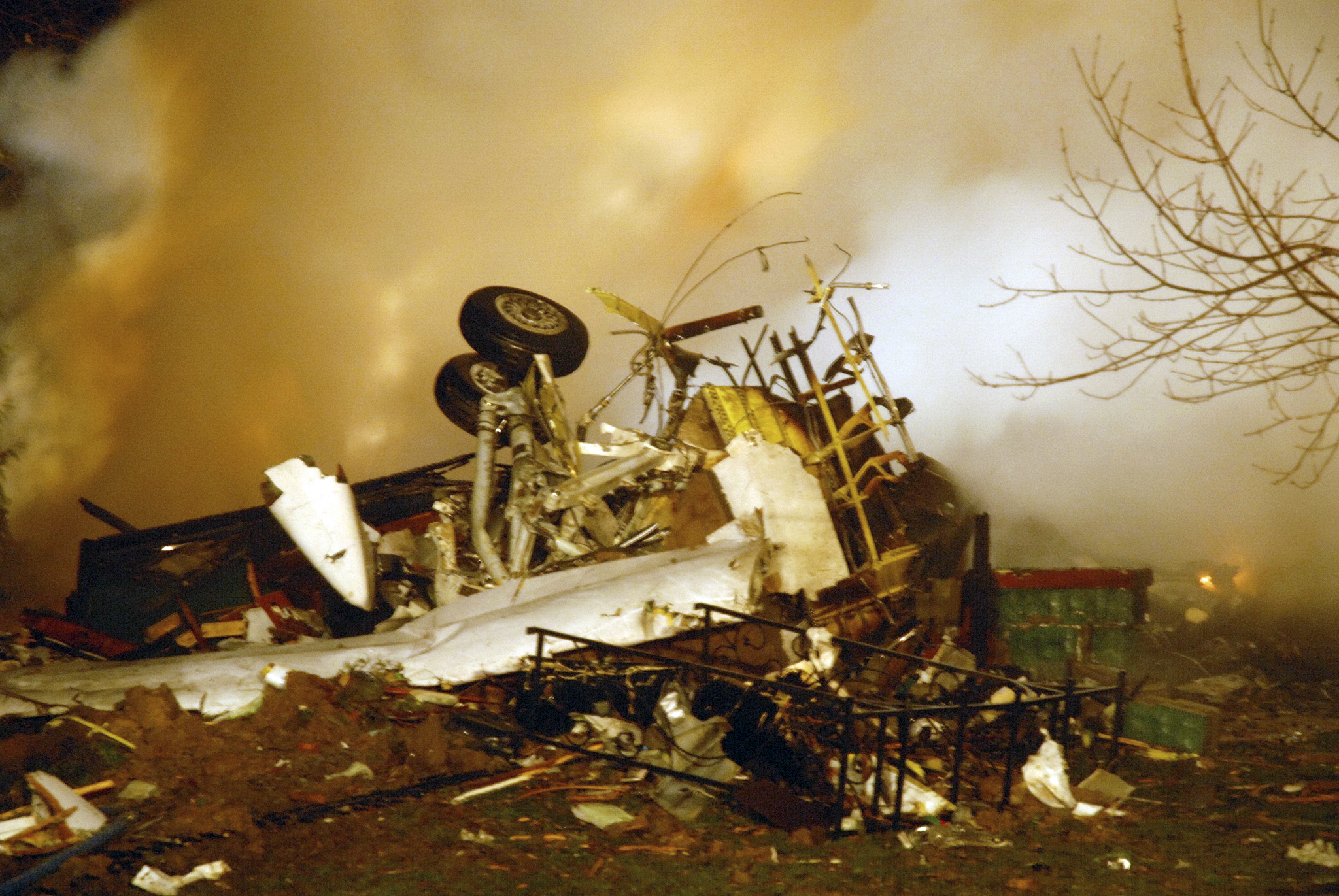 FILE - In this Feb. 12, 2009, file photo, the wreckage of Continental flight 3407 lies amid smoke at the scene after crashing into a suburban Buffalo home and erupting into flames. (AP Photo/Dave Sherman, File)