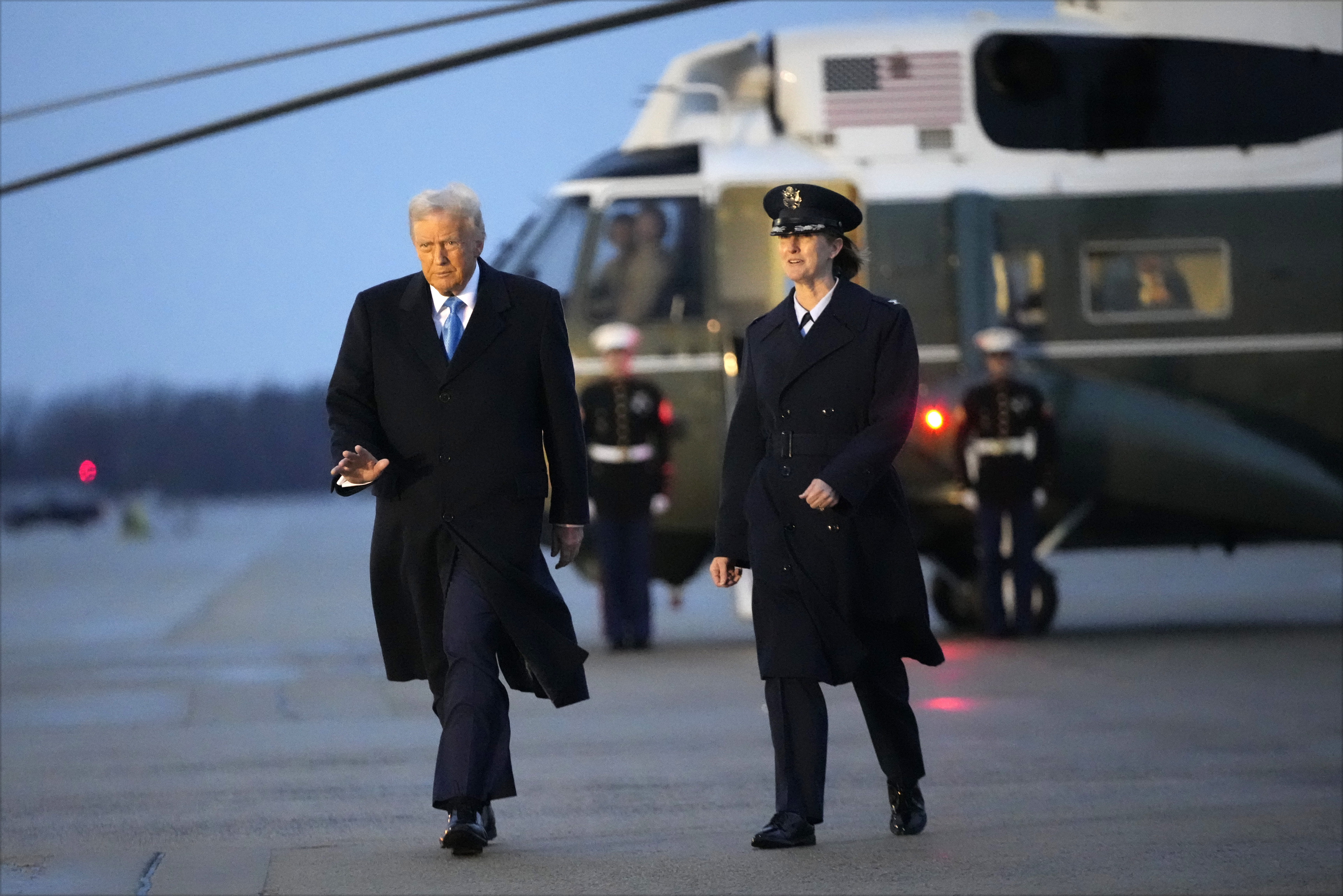 President Donald Trump walks with Col. Angela F. Ochoa, Commander, 89th Airlift Wing, before he boards Air Force One at Joint Base Andrews, Md., Friday, Jan. 31, 2025, en route to his Mar-a-Lago estate in Palm Beach, Fla. (AP Photo/Ben Curtis)