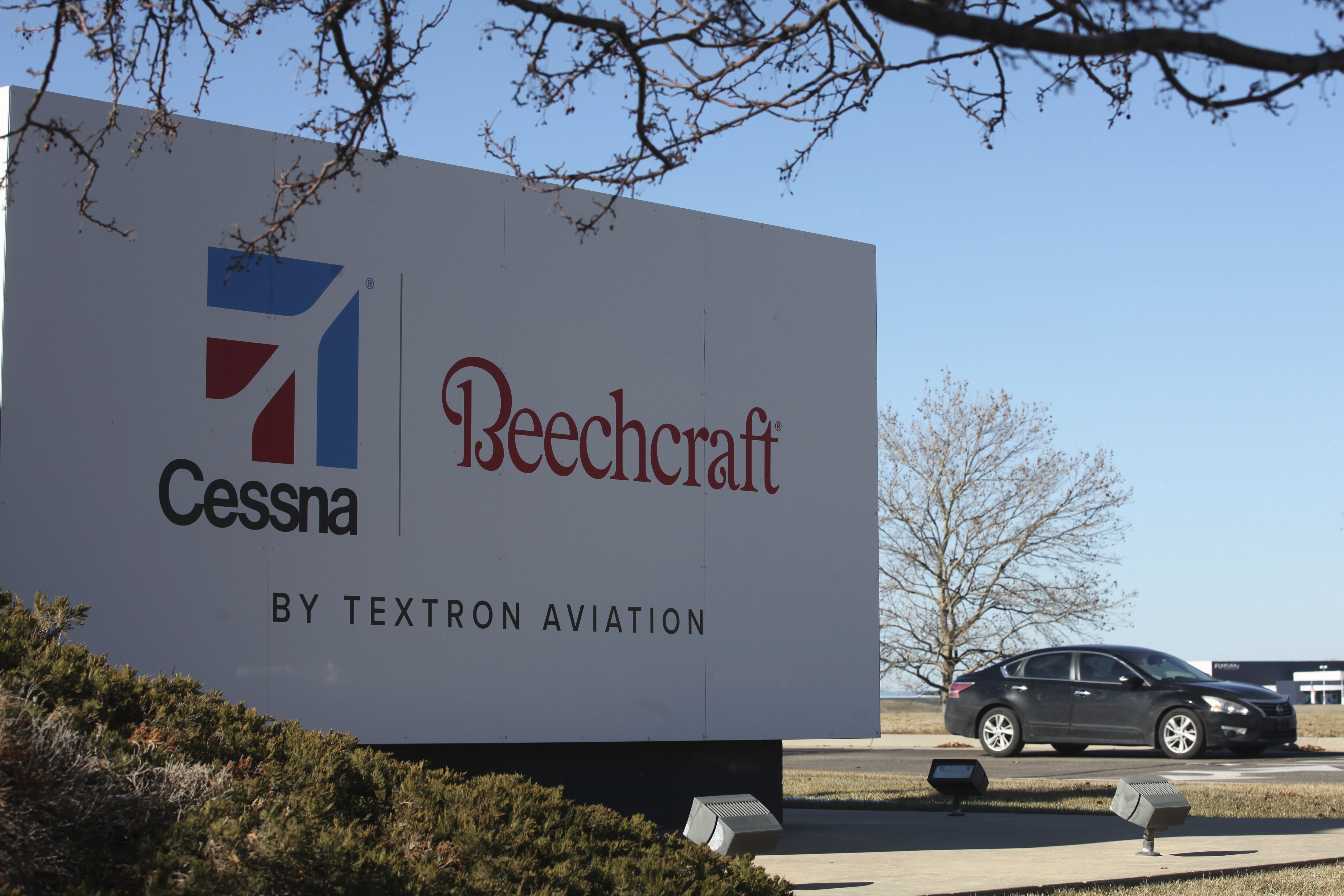 A sign marks an entrance to a plant for Textron Inc., which manufactures Cessna and Beechcraft airplanes, Friday, Jan. 31, 2025, in Wichita, Kan. (AP Photo/John Hanna)