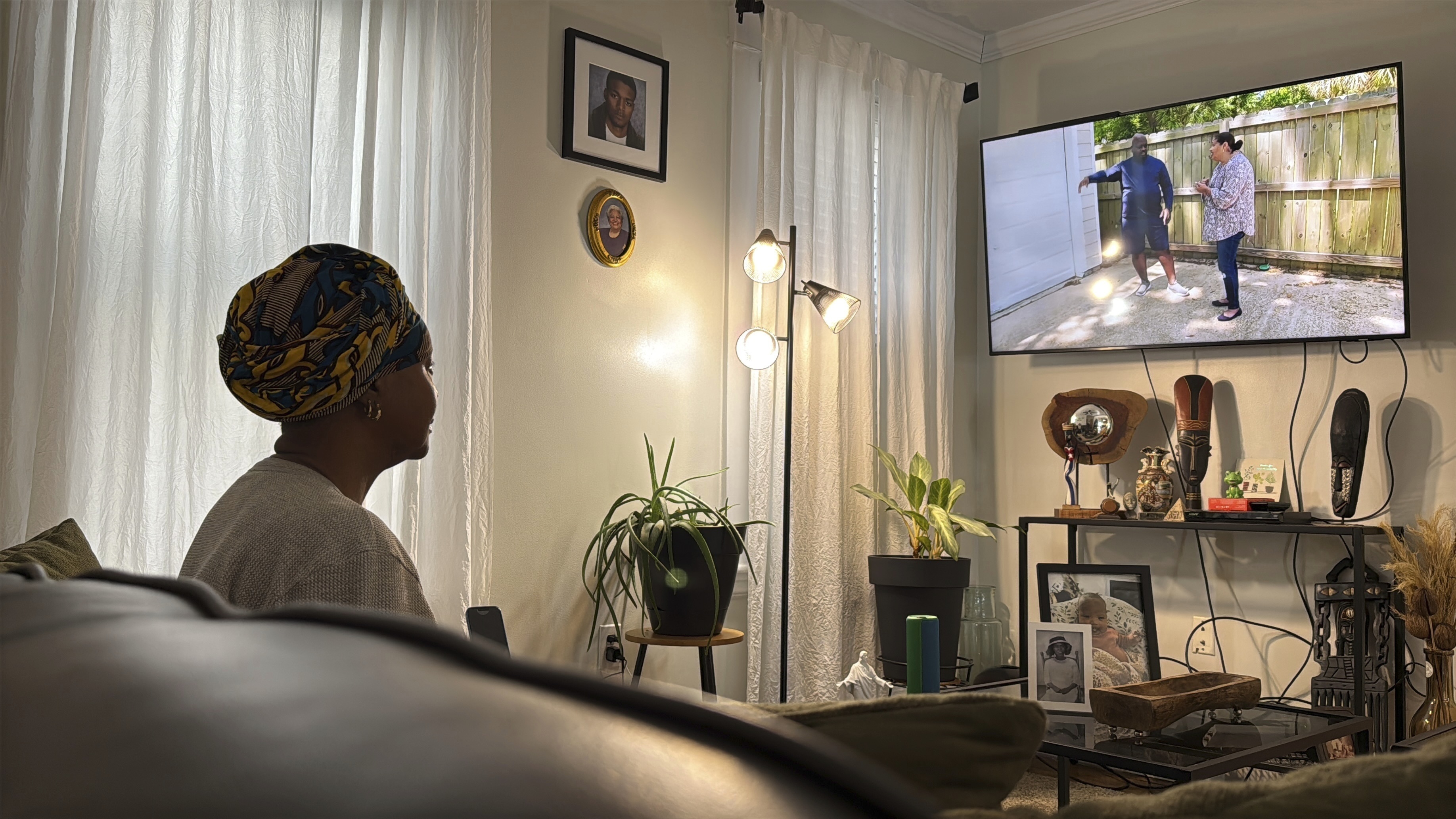 Julieta Lopez watches a house-hunting cable TV show in her home in Boston, Friday, Jan. 10, 2025, some two years after she bought her first home, capping a 30-year pursuit of homeownership. (AP Photo/Rodrique Ngowi)