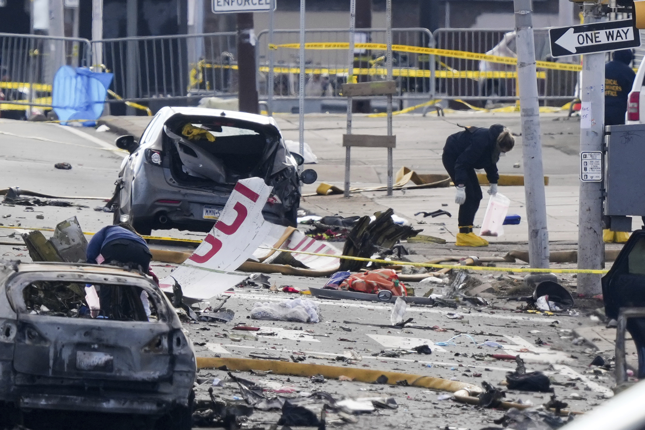 Investigators work the scene after a small plane crashed in Philadelphia, Saturday, Feb. 1, 2025. (AP Photo/Matt Rourke)