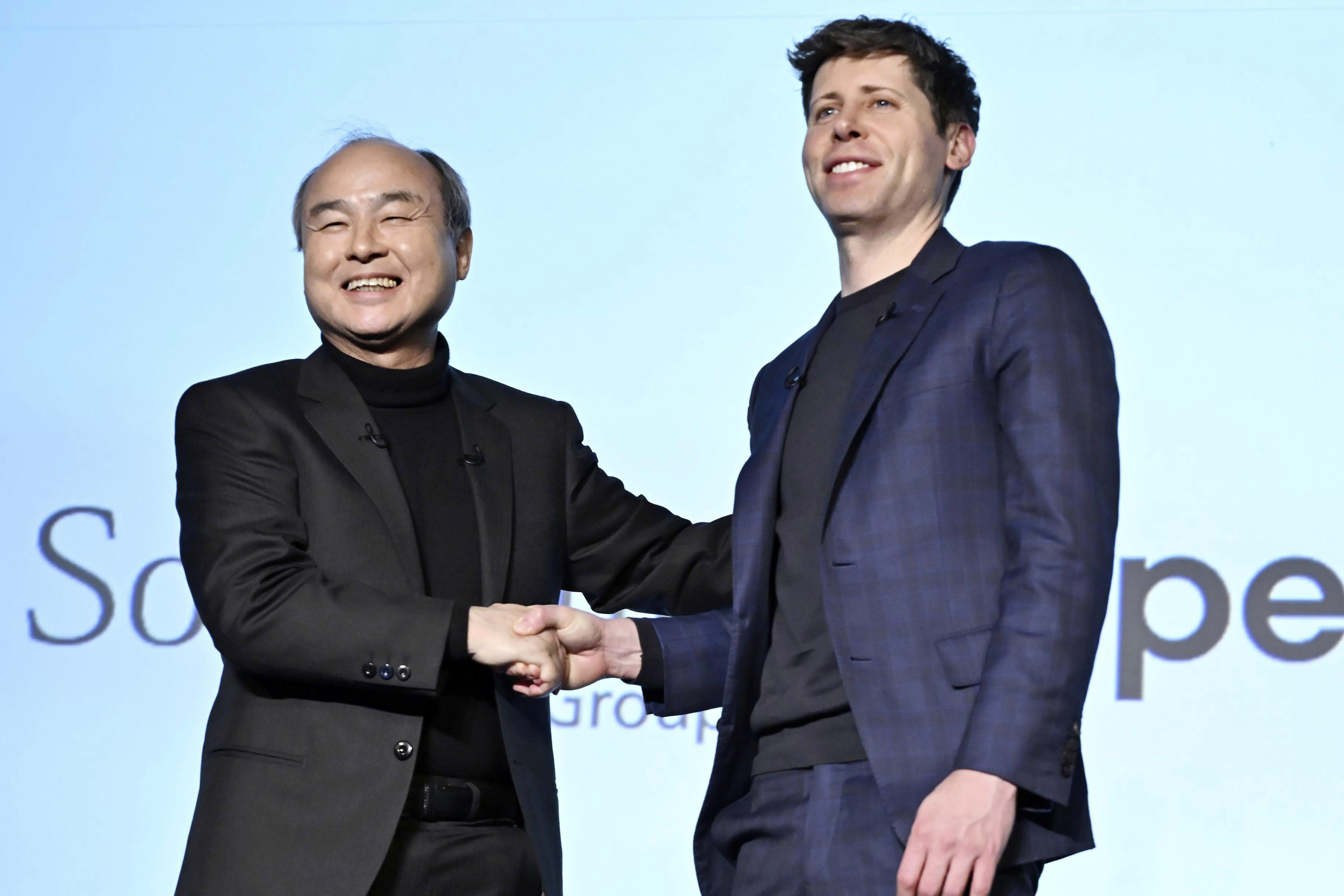 SoftBank Chief Masayoshi Son, left, and OpenAI Chief Sam Altman shake hands during an event in Tokyo, in Tokyo, Monday, Feb. 3, 2025. (Kyodo News via AP)