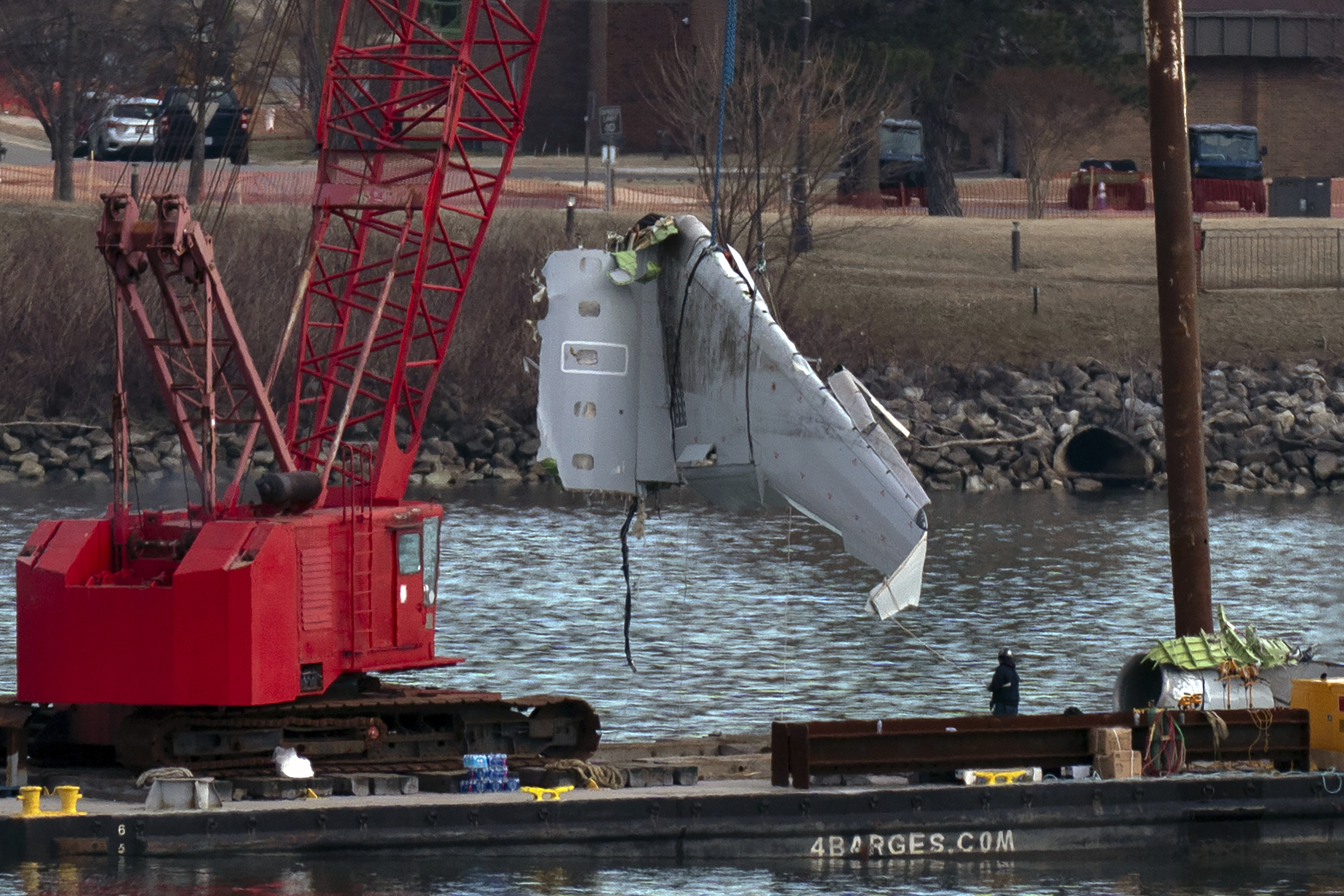 Rescue and salvage crews pull up airplane wreckage of an American Airlines jet in the Potomac River from Ronald Reagan Washington National Airport, Monday, Feb. 3, 2025, in Arlington, Va. (AP Photo/Jose Luis Magana)