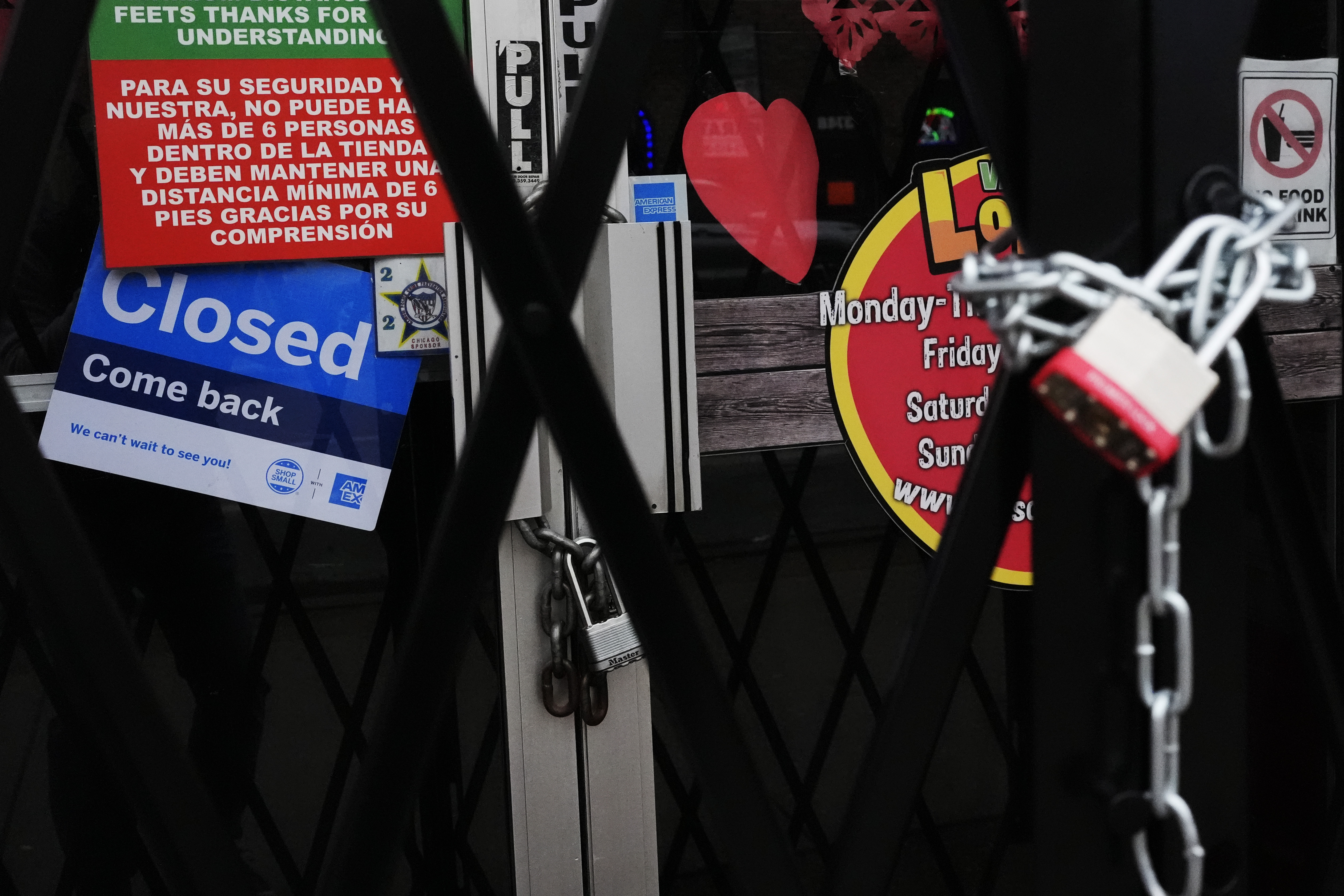 A closed sign is displayed at a mini grocery store in the Little Village neighborhood of Chicago, Monday, Feb. 3, 2025. (AP Photo/Nam Y. Huh)